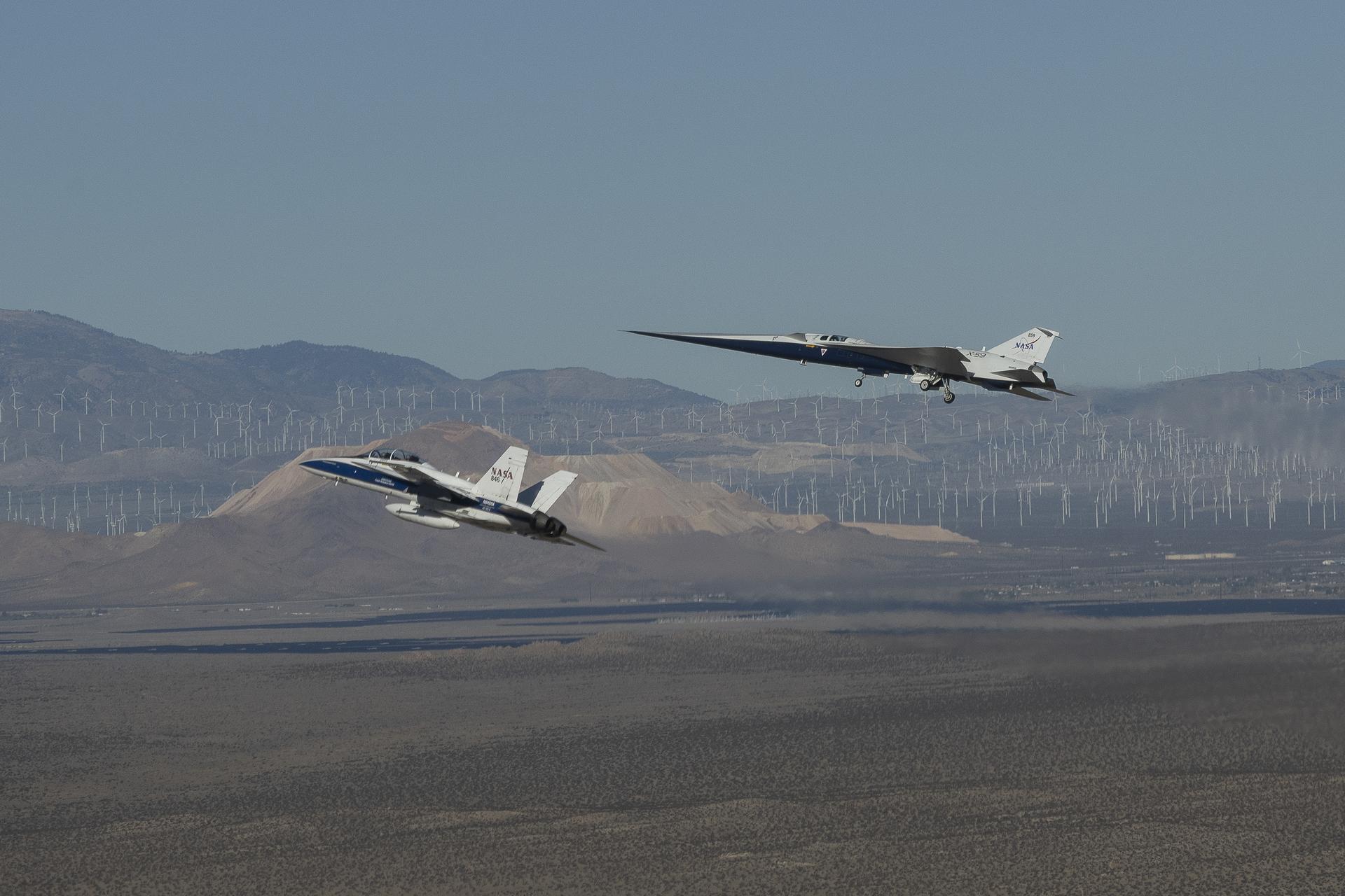 NASA’s X-59 quiet supersonic research aircraft flies above Palmdale and Edwards, California, on its first flight Tuesday, Oct. 28, 2025, accompanied by a NASA F-15 research aircraft. The F-15 monitored the X-59 during the flight as it traveled to NASA’s Armstrong Flight Research Center in Edwards, California, where it will begin flight testing for NASA’s Quesst mission, which aims to demonstrate quiet supersonic flight over land.