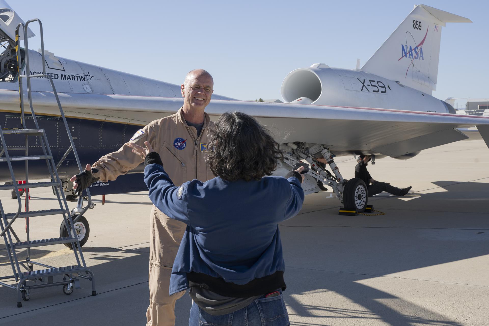 NASA test pilot Nils Larson reaches for a hug from his wife after completing the X-59’s first flight on Tuesday, Oct. 28, 2025. The mission marked a key milestone in advancing NASA’s Quesst effort to enable quiet supersonic flight over land.