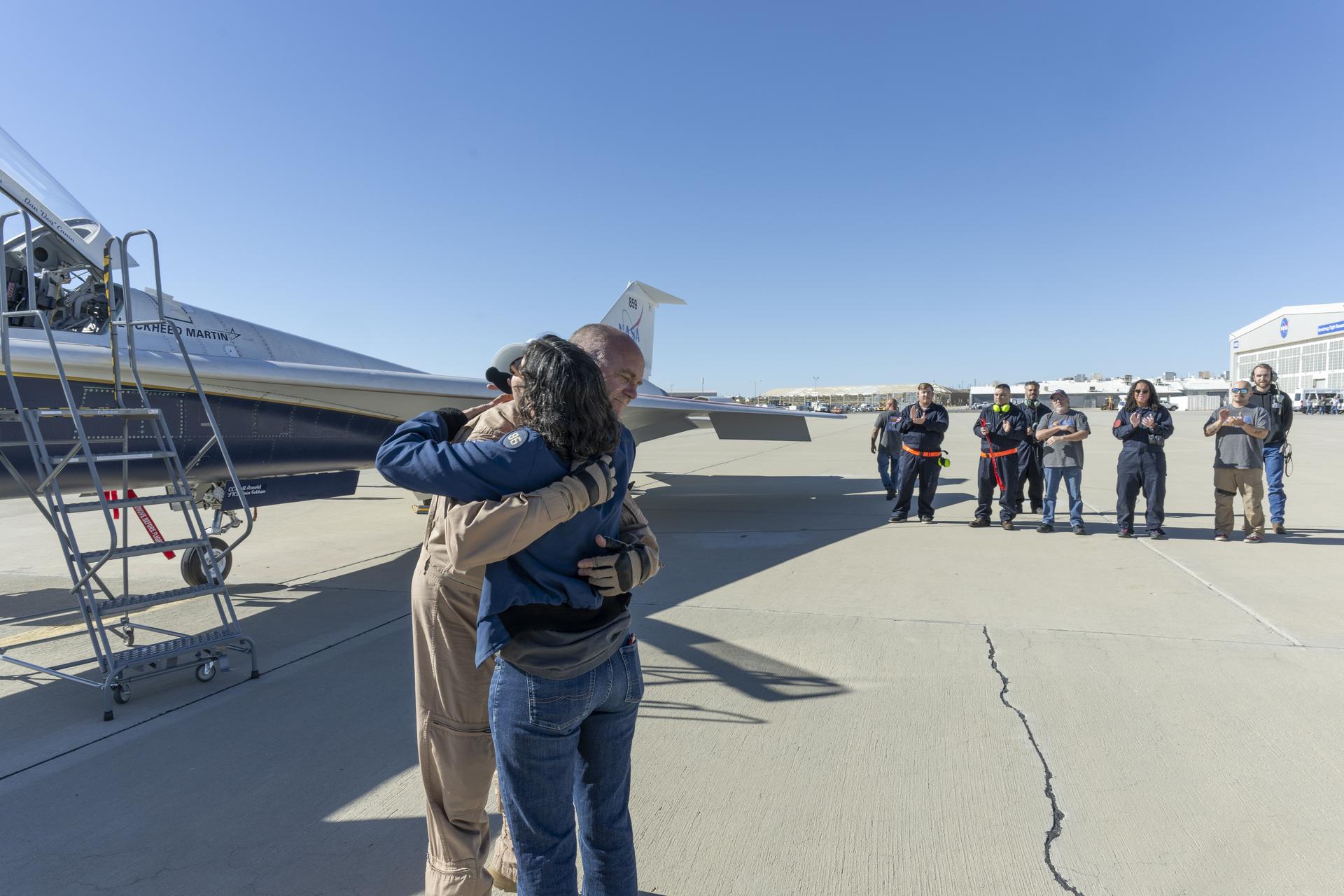 NASA test pilot Nils Larson reaches for a hug from his wife after completing the X-59’s first flight on Tuesday, Oct. 28, 2025. The mission marked a key milestone in advancing NASA’s Quesst effort to enable quiet supersonic flight over land.