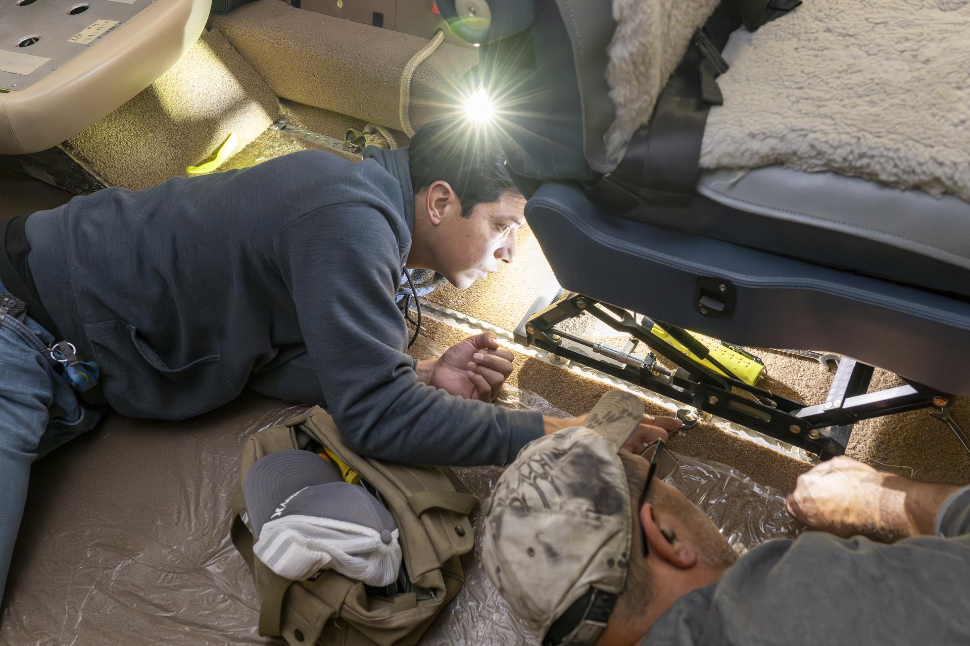 Manny Rodriguez, Gulfstream G-III aircraft crew chief, left, and Eric Apikian, aircraft mechanic, attach an instrumented seat onto a G-III on Wednesday, Jan. 7, 2026, at NASA’s Armstrong Flight Research Center in Edwards, California. The modifications prepare the aircraft to join three others flying at different altitudes to capture a complete view of the Orion spacecraft’s heat shield during Artemis II reentry. This effort is part of NASA’s Scientifically Calibrated In-Flight Imagery project.