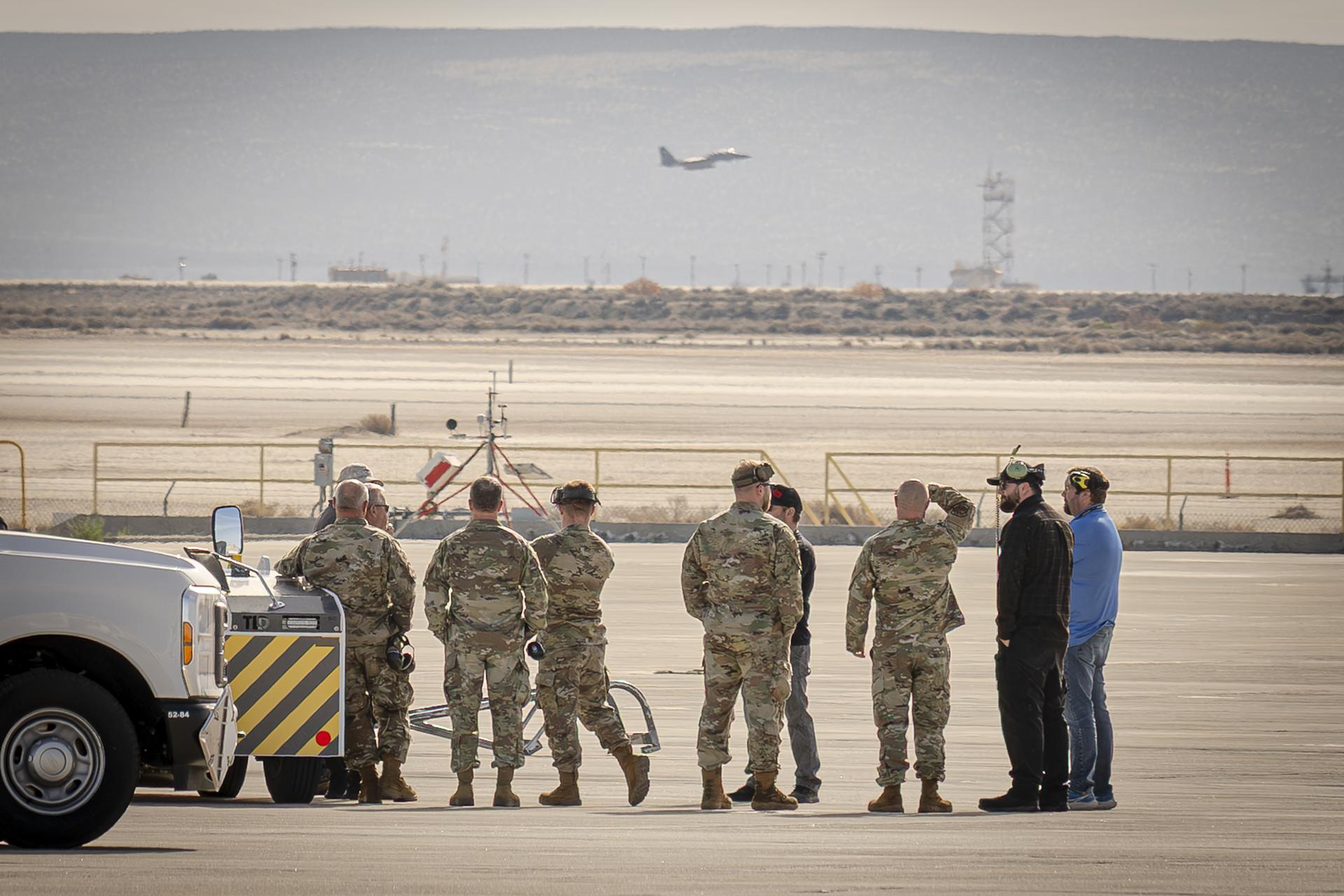 Oregon Air National Guard and NASA flight crew look out across the desert while awaiting the arrival of the NASA’s newest F-15 aircraft from the Oregon Air National Guard’s 173rd Fighter Wing to NASA’s Armstrong Flight Research Center in Edwards, California, on Monday, Dec. 22, 2025.