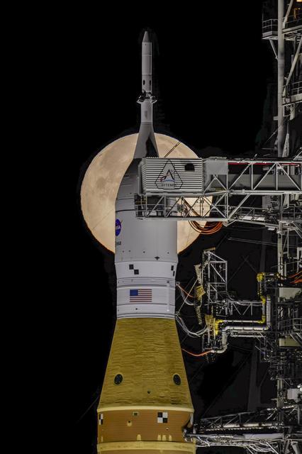 The Moon sets behind NASA’s Artemis II SLS (Space Launch System) rocket and O...