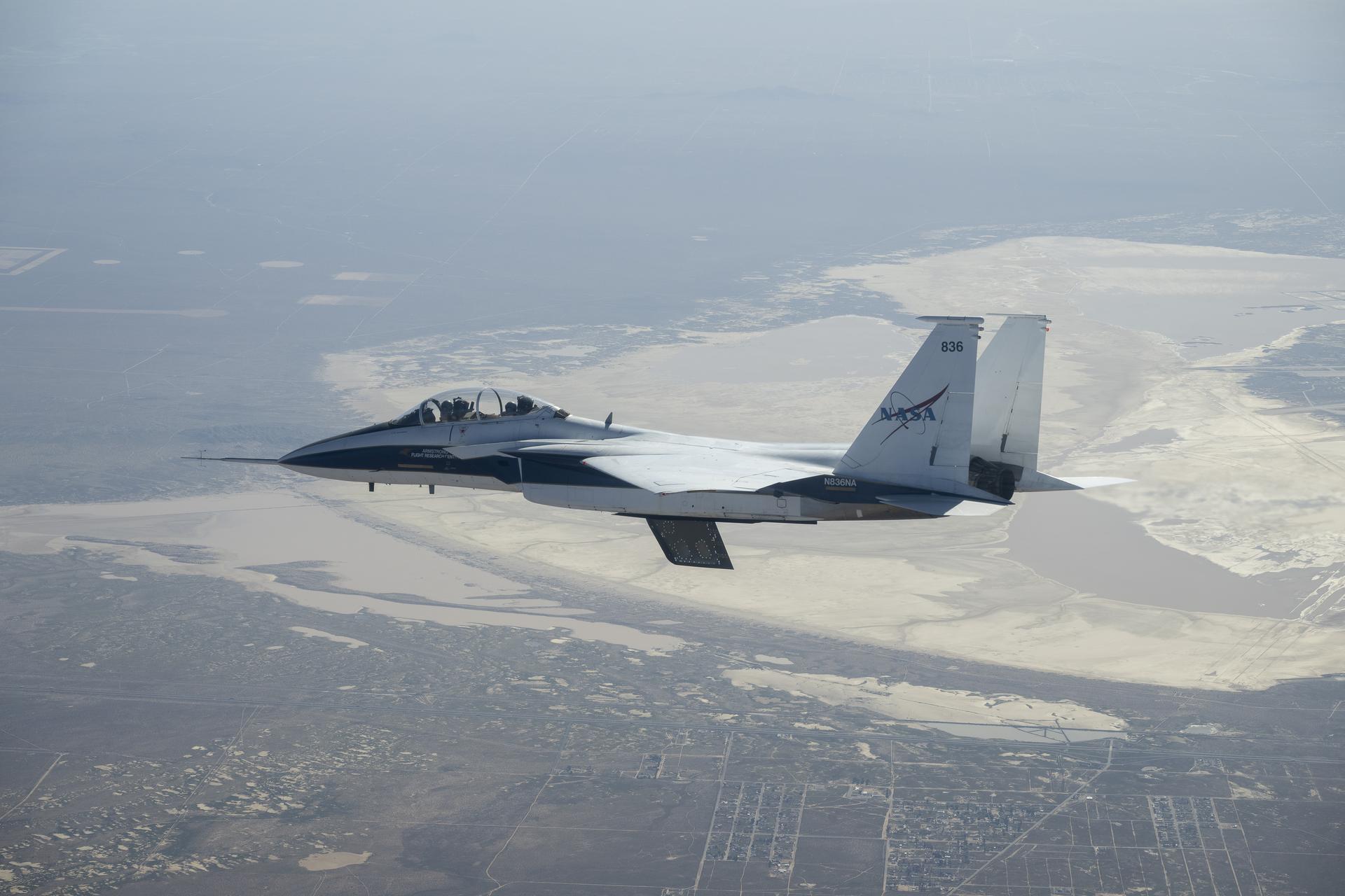 NASA’s Crossflow Attenuated Natural Laminar Flow (CATNLF) scale-model wing flies for the first time on a NASA F-15 research jet during a test flight from NASA’s Armstrong Flight Research Center in Edwards, California. The 75-minute flight confirmed the aircraft could maneuver safely with the approximately 3-foot-tall test article mounted beneath it. NASA will continue flight tests to collect data that validates the CATNLF design and its potential to improve laminar flow, reducing drag and lowering fuel costs for future commercial aircraft. 