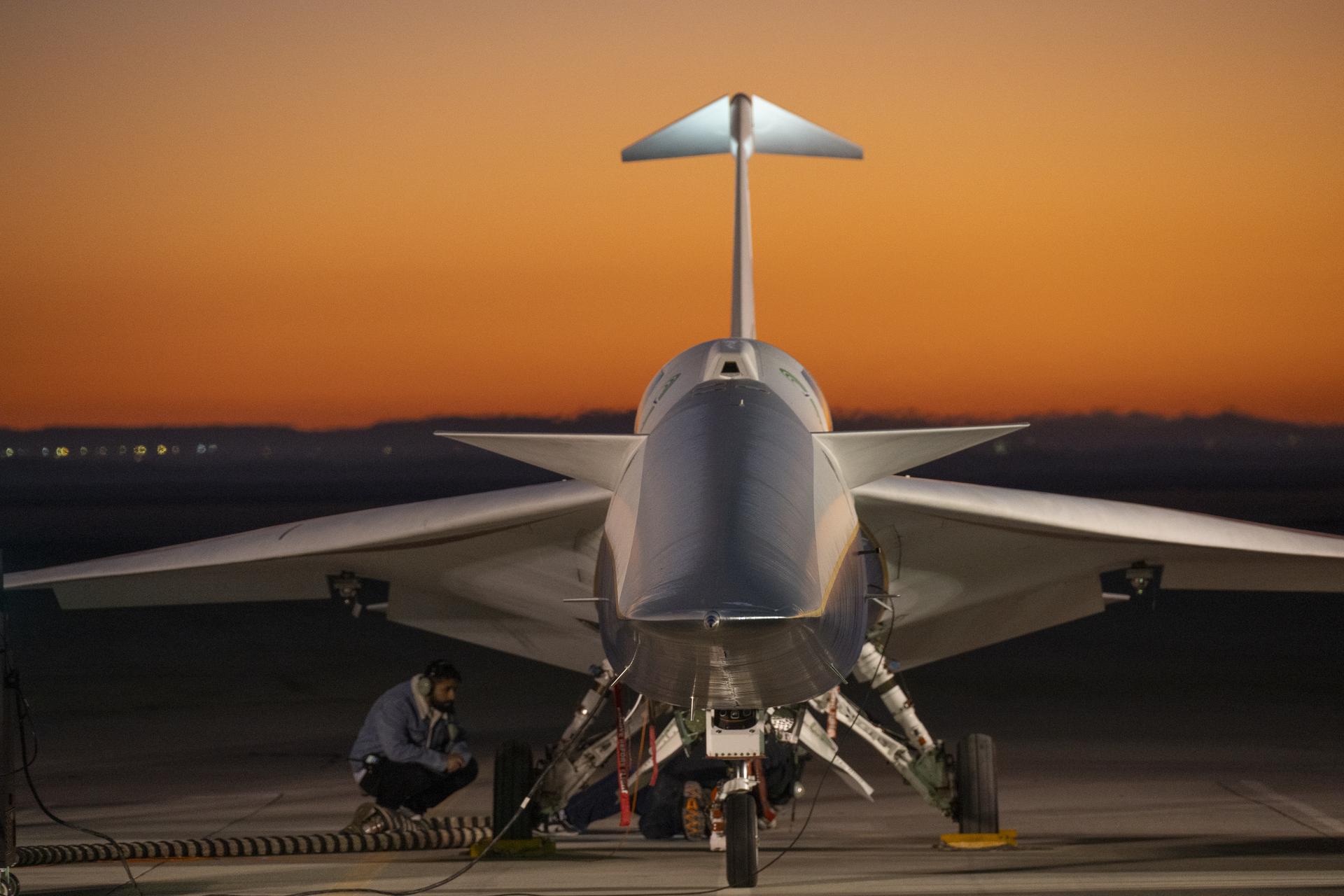 NASA’s X-59 quiet supersonic research aircraft sits on a ramp during engine run tests at NASA’s Armstrong Flight Research Center in Edwards, California, on Thursday, March 12, 2026. A maintenance technician inspects the aircraft near its landing gear as engine runs, one of the final tests before the aircraft’s second flight, take place.