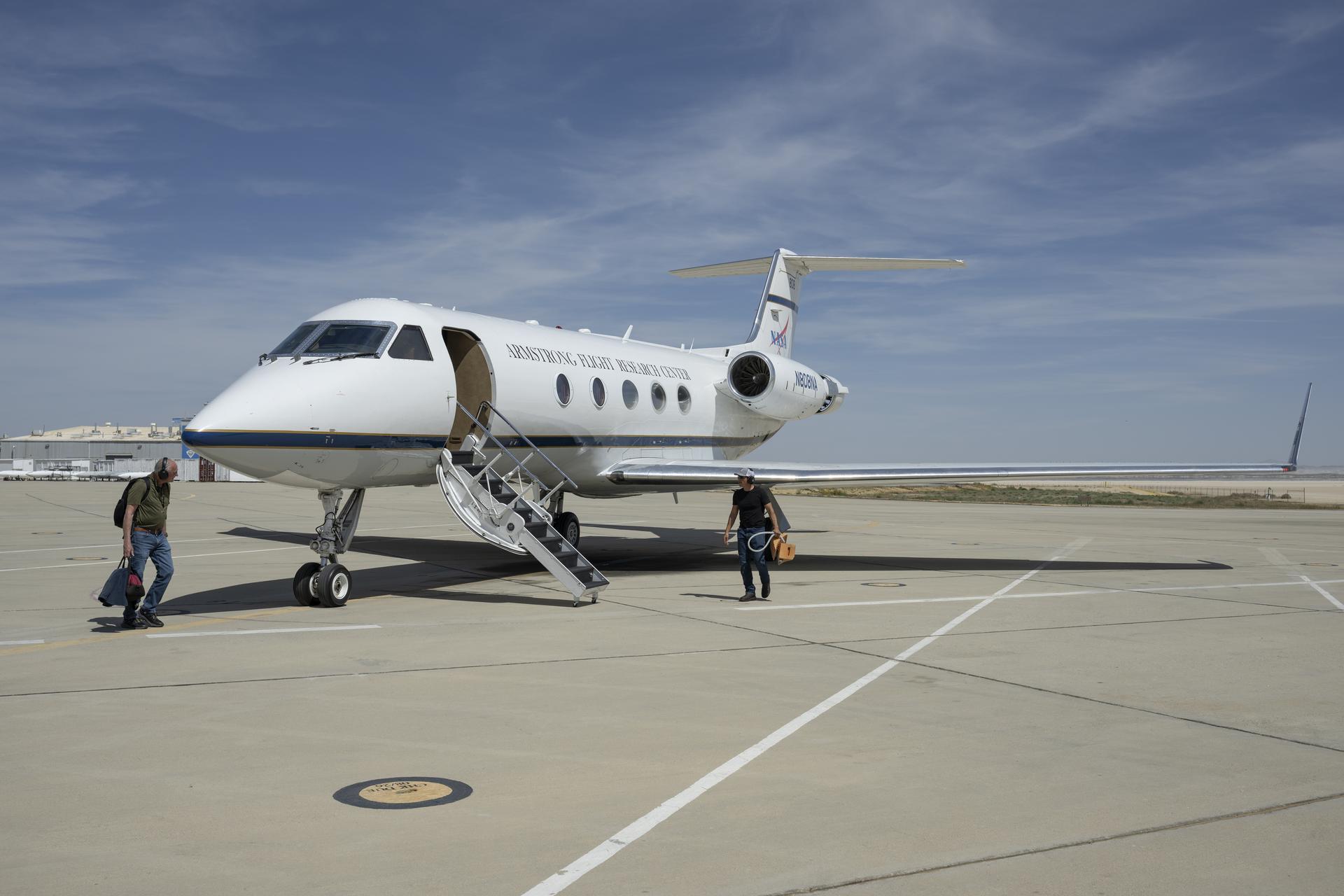 Scott Erickson, left, a quality assurance inspector, and Manny Rodriguez, Gulfstream G-III crew chief, prepare the aircraft for flight on Friday, March 27, 2026, at NASA’s Armstrong Flight Research Center in Edwards, California. The G-III will join other NASA aircraft to capture imagery of the Orion spacecraft’s heat shield during Artemis II reentry. The mission is part of NASA’s Scientifically Calibrated In-Flight Imagery (SCIFLI) project, based at NASA’s Langley Research Center in Hampton, Virginia.