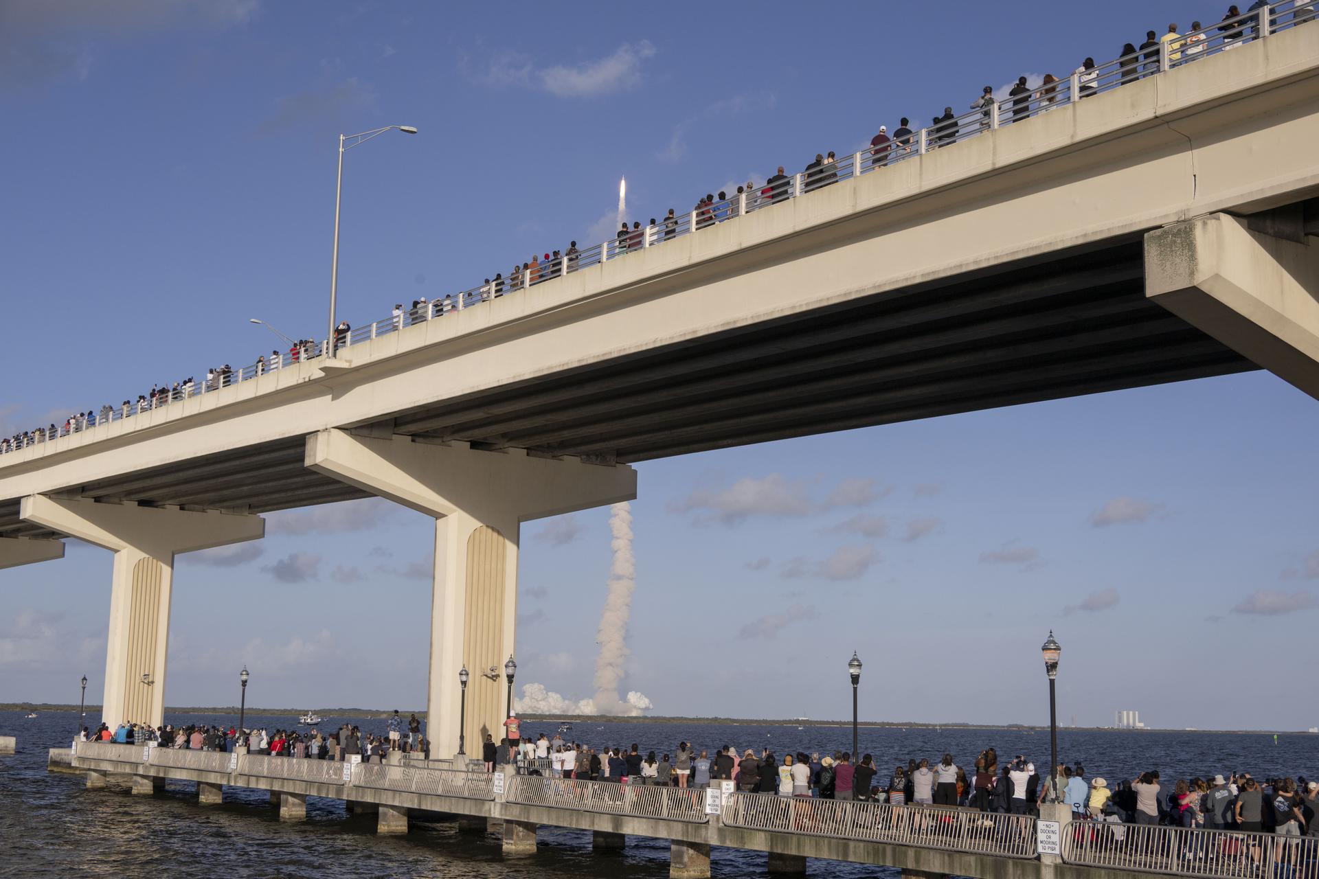 Crowds gather at the Max A. Brewer Bridge in Titusville to watch the launch of NASA’s SLS (Space Launch System) rocket with the Orion spacecraft carrying Artemis II Commander Reid Wiseman, Pilot Victor Glover, and Mission Specialist Christina Koch from NASA, along with Mission Specialist Jeremy Hansen from the CSA (Canadian Space Agency), on Wednesday, April 1, 2026, from Launch Complex 39B at NASA Kennedy. The Artemis II test flight will take the crew members on a 10-day journey around the Moon and back.  