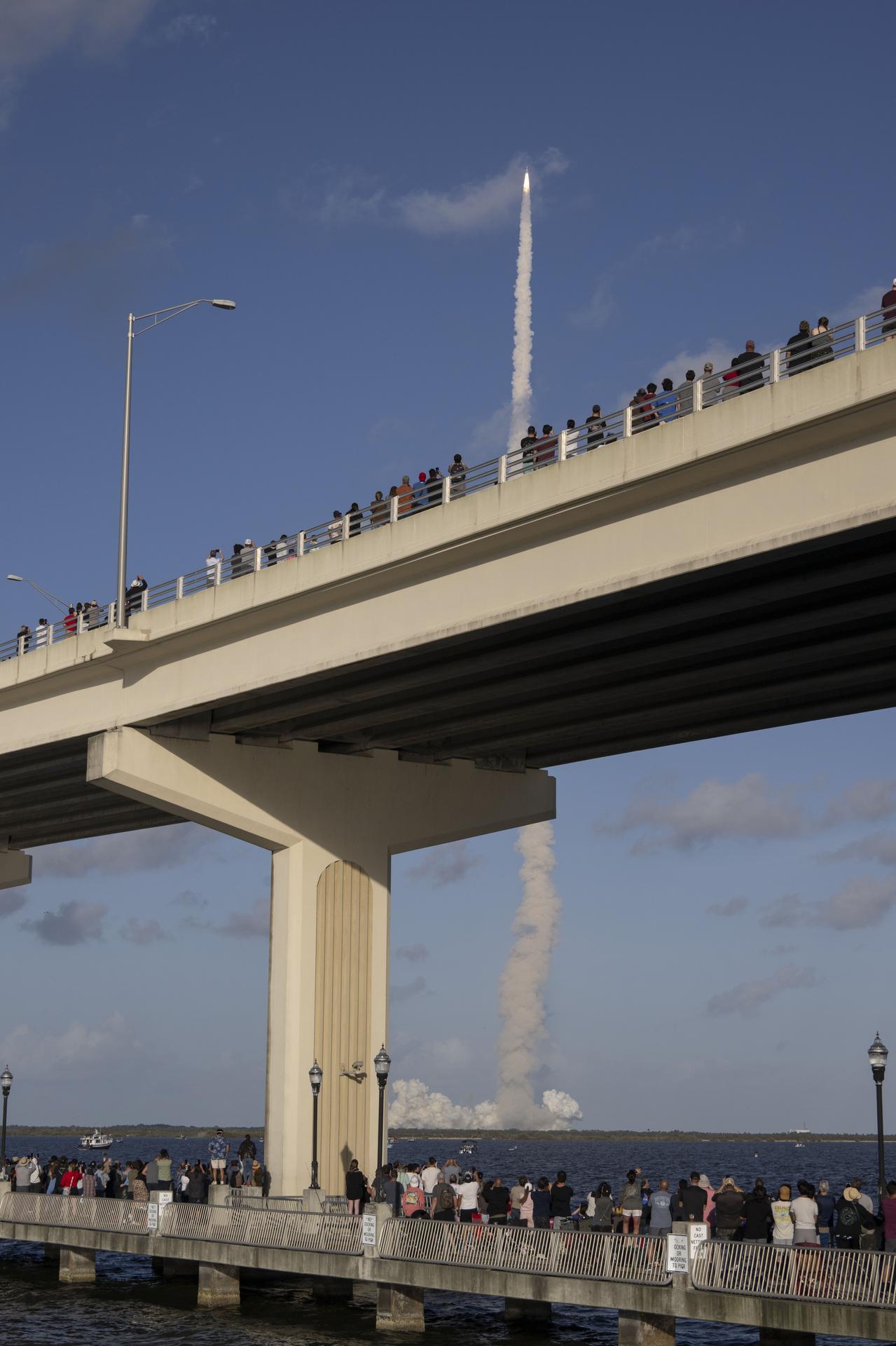 Crowds gather at the Max A. Brewer Bridge in Titusville to watch the launch of NASA’s SLS (Space Launch System) rocket with the Orion spacecraft carrying Artemis II Commander Reid Wiseman, Pilot Victor Glover, and Mission Specialist Christina Koch from NASA, along with Mission Specialist Jeremy Hansen from the CSA (Canadian Space Agency), on Wednesday, April 1, 2026, from Launch Complex 39B at NASA Kennedy. The Artemis II test flight will take the crew members on a 10-day journey around the Moon and back.  