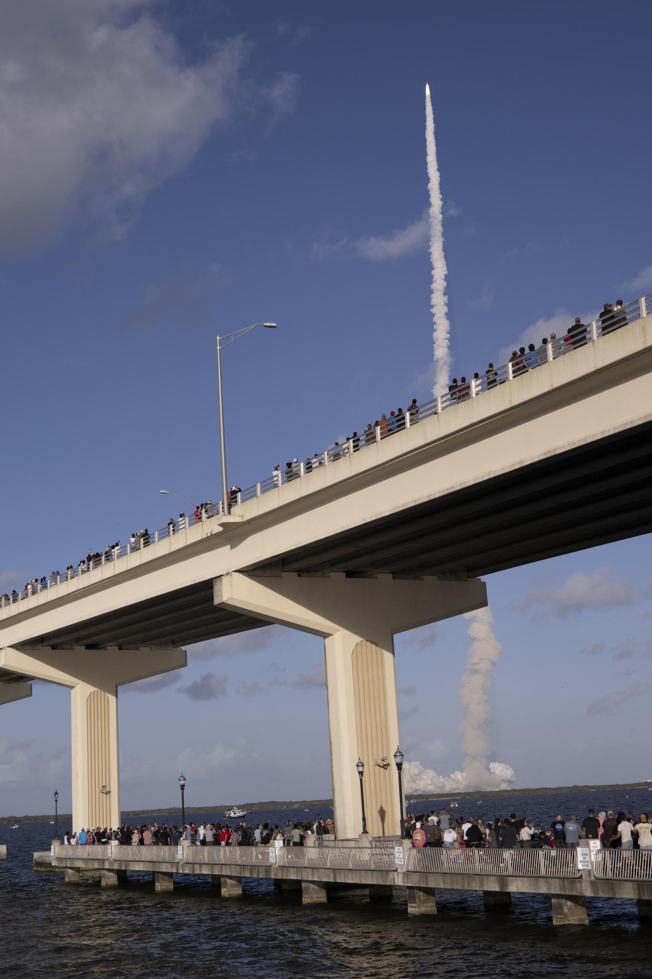 Crowds gather at the Max A. Brewer Bridge in Titusville to watch the launch of NASA’s SLS (Space Launch System) rocket with the Orion spacecraft carrying Artemis II Commander Reid Wiseman, Pilot Victor Glover, and Mission Specialist Christina Koch from NASA, along with Mission Specialist Jeremy Hansen from the CSA (Canadian Space Agency), on Wednesday, April 1, 2026, from Launch Complex 39B at NASA Kennedy. The Artemis II test flight will take the crew members on a 10-day journey around the Moon and back.  
