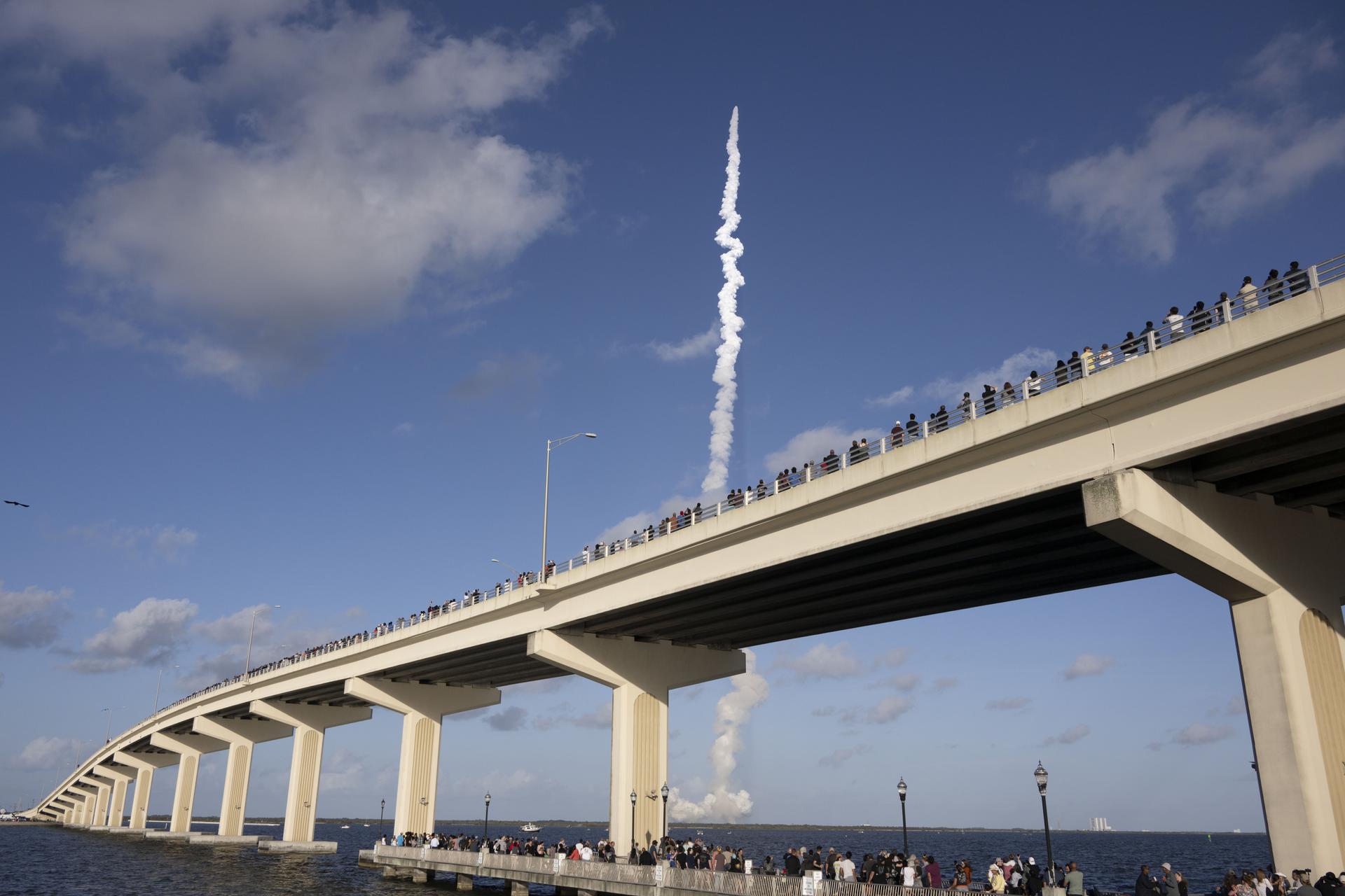 Crowds gather at the Max A. Brewer Bridge in Titusville to watch the launch of NASA’s SLS (Space Launch System) rocket with the Orion spacecraft carrying Artemis II Commander Reid Wiseman, Pilot Victor Glover, and Mission Specialist Christina Koch from NASA, along with Mission Specialist Jeremy Hansen from the CSA (Canadian Space Agency), on Wednesday, April 1, 2026, from Launch Complex 39B at NASA Kennedy. The Artemis II test flight will take the crew members on a 10-day journey around the Moon and back.  