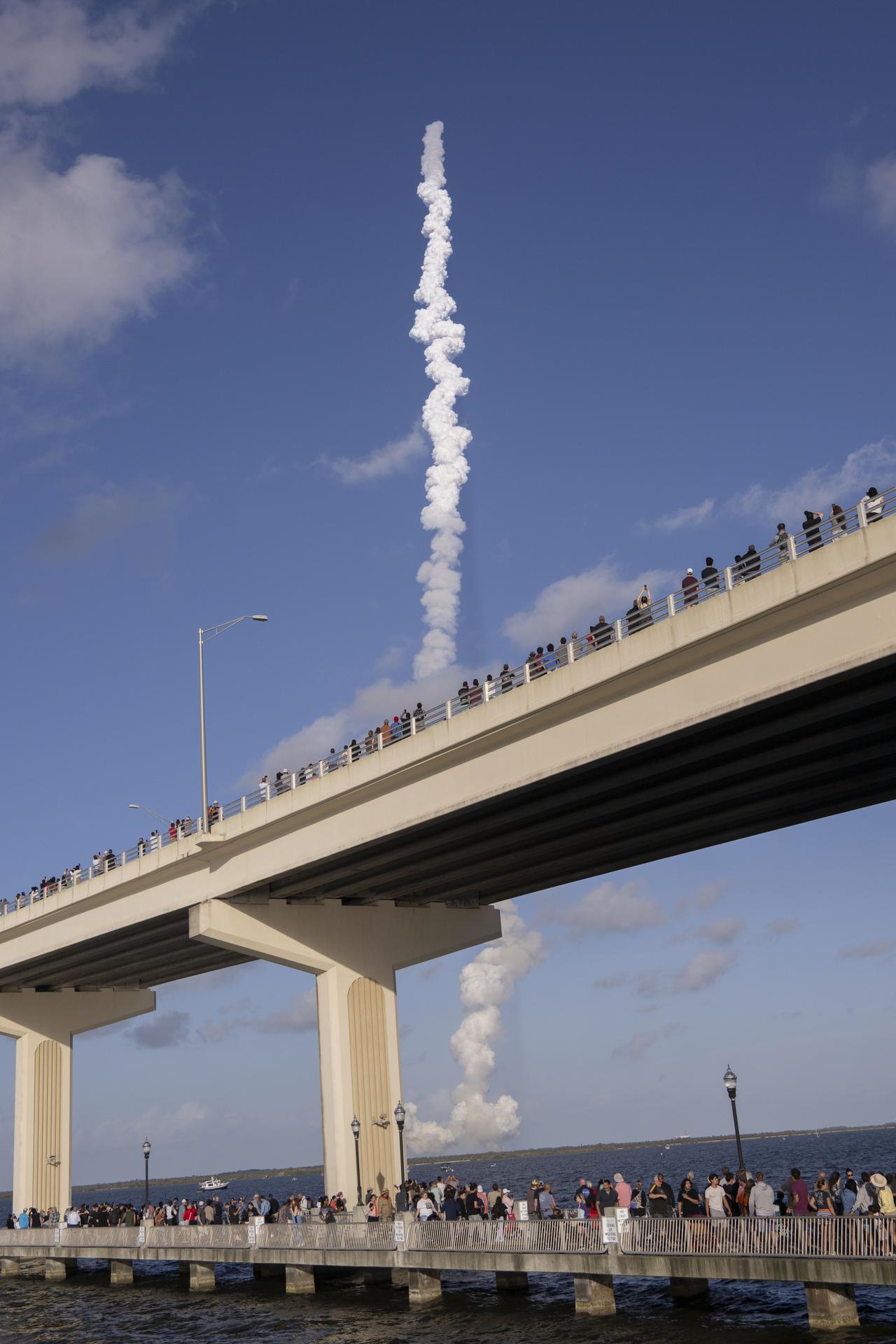 Crowds gather at the Max A. Brewer Bridge in Titusville to watch the launch of NASA’s SLS (Space Launch System) rocket with the Orion spacecraft carrying Artemis II Commander Reid Wiseman, Pilot Victor Glover, and Mission Specialist Christina Koch from NASA, along with Mission Specialist Jeremy Hansen from the CSA (Canadian Space Agency), on Wednesday, April 1, 2026, from Launch Complex 39B at NASA Kennedy. The Artemis II test flight will take the crew members on a 10-day journey around the Moon and back.  