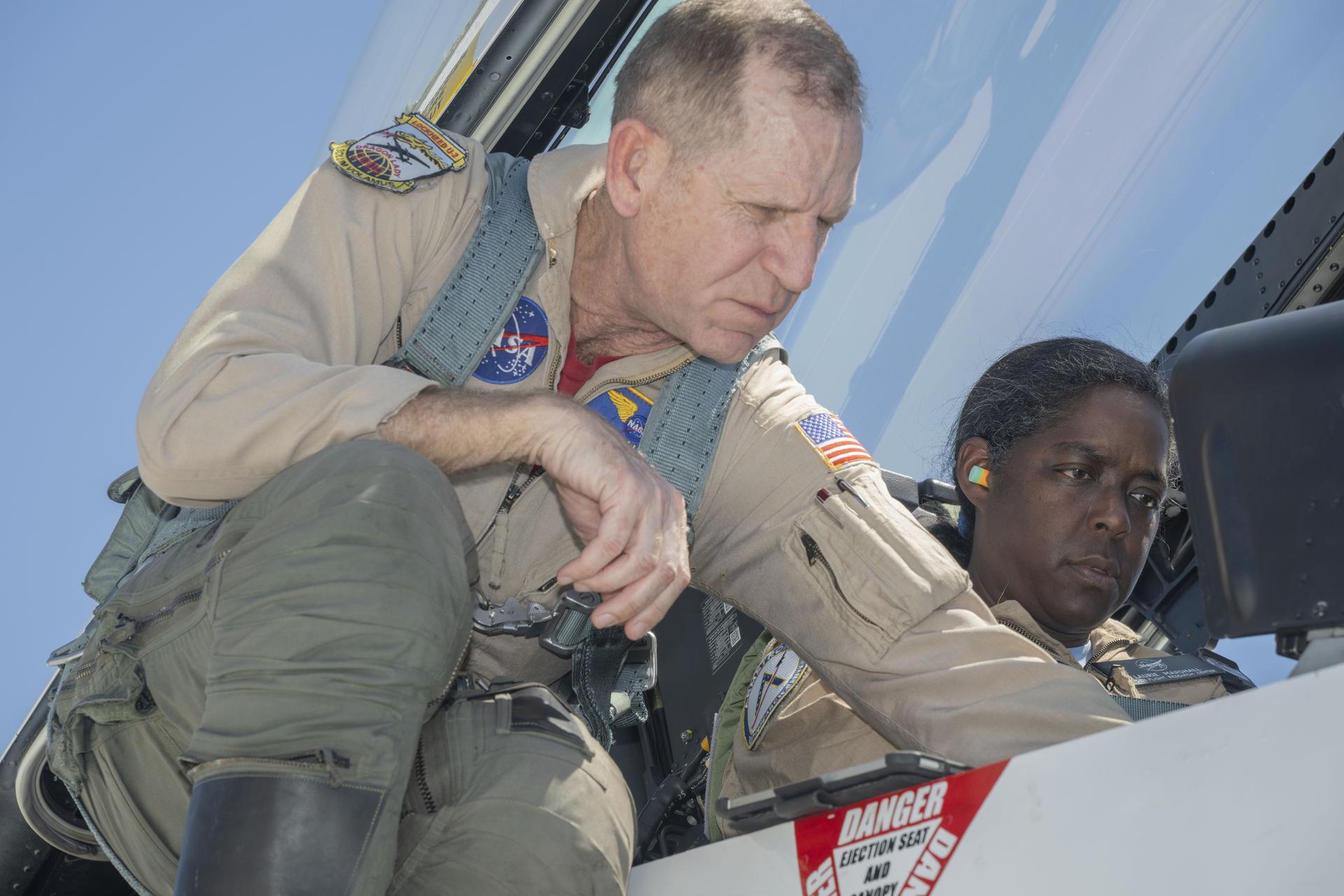 NASA pilot Timothy Williams helps prepare Laurie Grindle, deputy center director, for an employee incentive flight in an F/A-18 aircraft at NASA’s Armstrong Flight Research Center in Edwards, California, on Tuesday, April 14, 2026. NASA Administrator Jared Isaacman established the ride‑along program to recognize and reward workforce members for their dedication to advancing the agency’s priorities.
