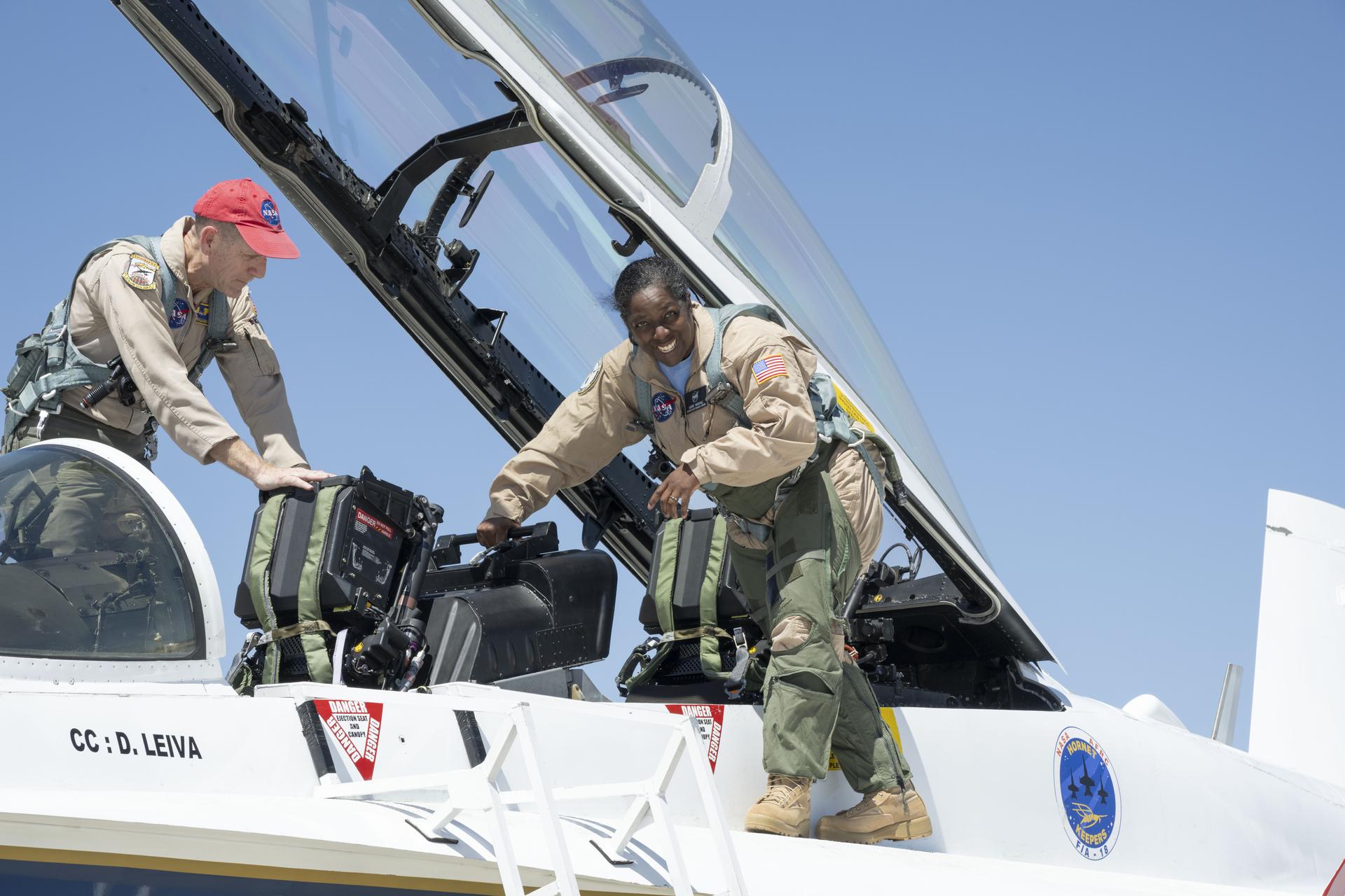Laurie Grindle, deputy center director, steps out of an F/A-18 aircraft after completing an employee incentive flight at NASA’s Armstrong Flight Research Center in Edwards, California, on Tuesday, April 14, 2026. Timothy Williams, the pilot, secures the F/A-18 cockpit. NASA Administrator Jared Isaacman established the ride‑along program to recognize and reward workforce members for their dedication to advancing the agency’s priorities.