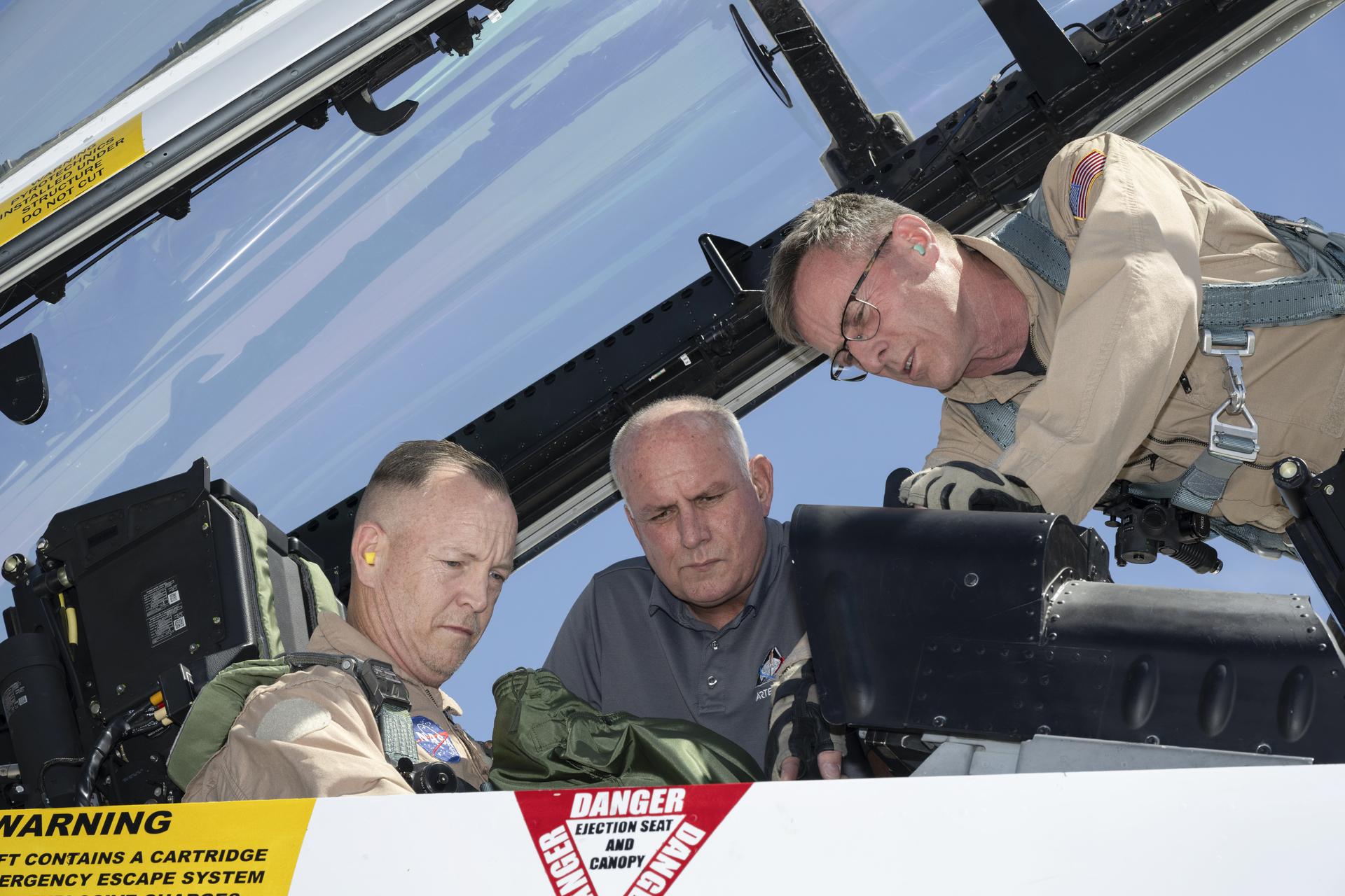  NASA pilot Jim Less and Phil Wellner, aircrew life support technician, help prepare Mike Frederick, aerospace engineer and researcher, for an employee incentive flight in an F/A-18 aircraft at NASA’s Armstrong Flight Research Center in Edwards, California, on Wednesday, April 15, 2026. NASA Administrator Jared Isaacman established the ride‑along program to recognize and reward workforce members for their dedication to advancing the agency’s priorities.