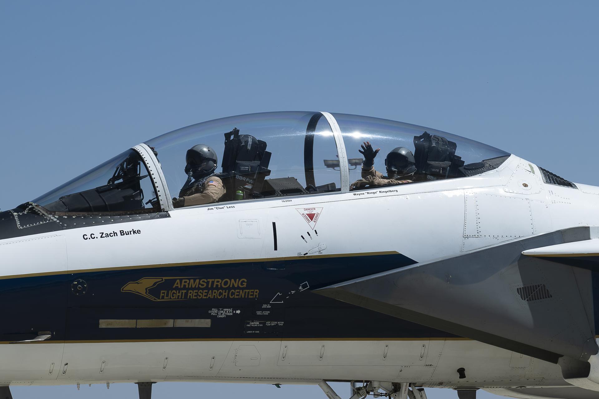 NASA aerial photographer Carla Thomas waves from the backseat of a NASA F-15 aircraft as chief pilot Wayne Ringelberg taxis following Thomas’ 1,000th flight at NASA’s Armstrong Flight Research Center in Edwards, California, on Monday, April 20, 2026. For 38 years, Thomas has captured aerial photographs of research and science flights.
