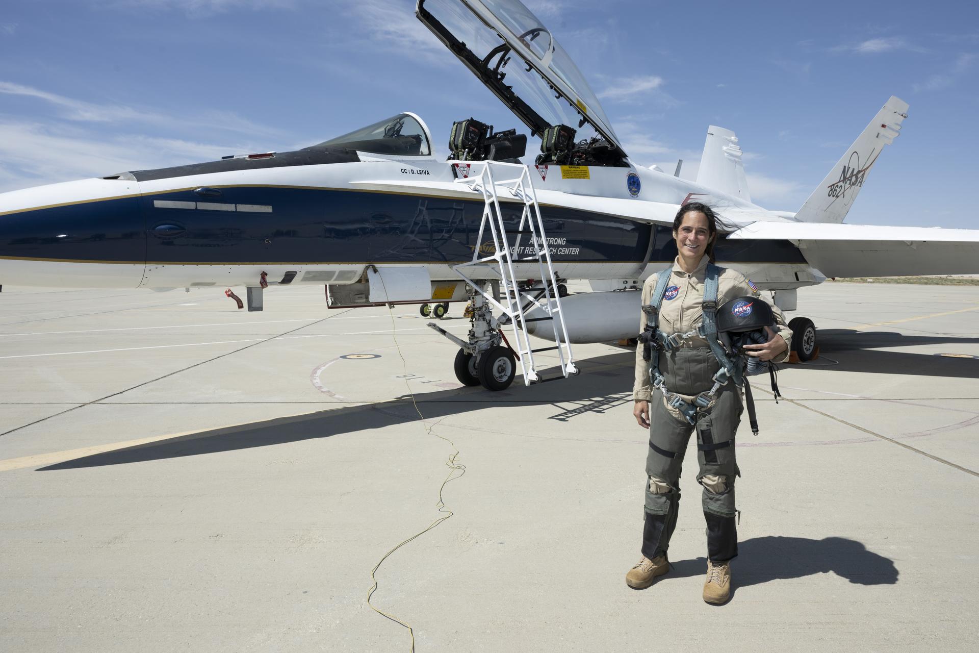 Sarah D’Souza, deputy systems manager for the Orion Thermal Protection System, stands in front of an F/A-18 aircraft at NASA’s Armstrong Flight Research Center in Edwards, California, ahead of her flight through NASA Administrator Jared Isaacman’s ride-along program. The program recognizes and rewards workforce members for their dedication to advancing the agency’s priorities. Credit: NASA