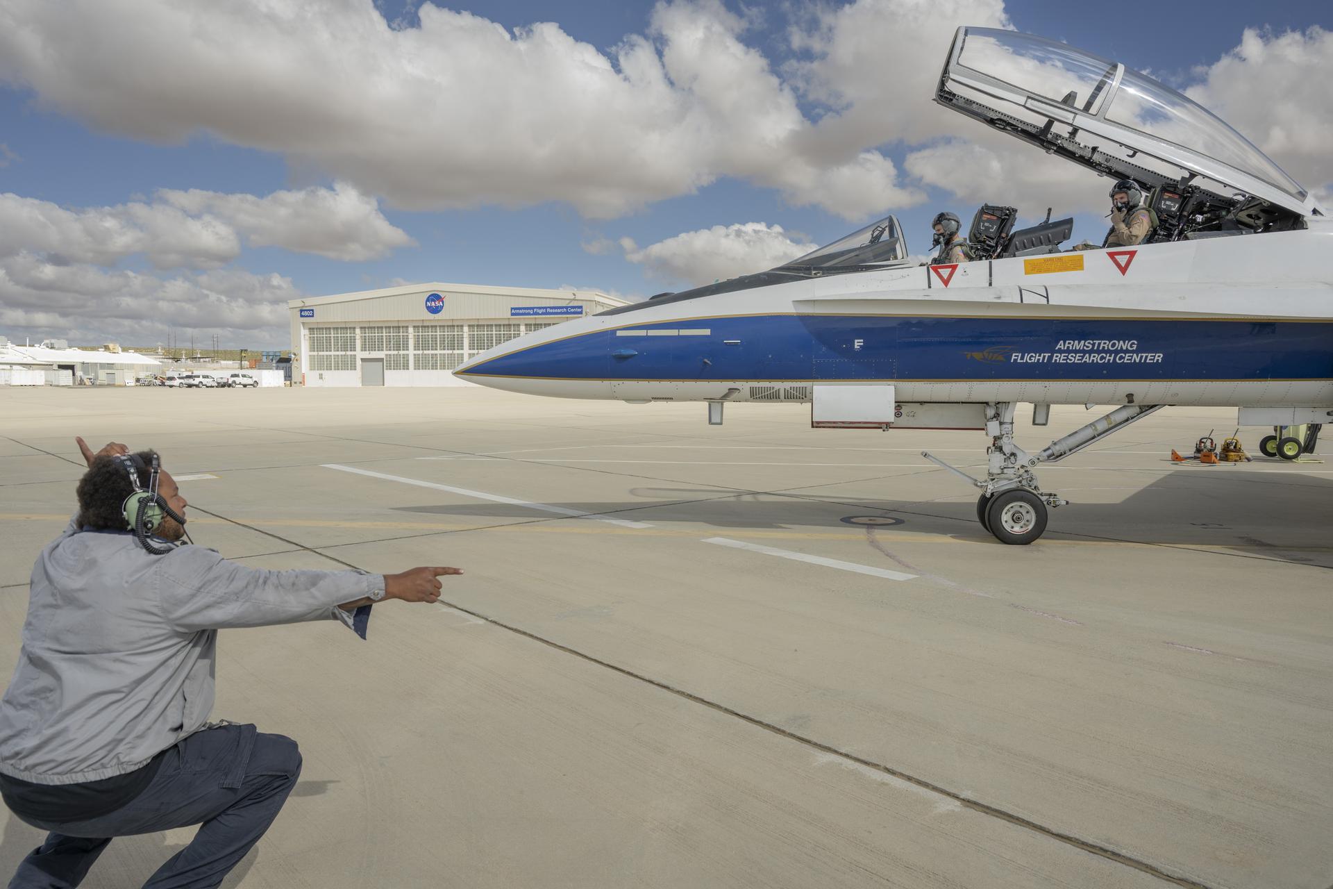 Crew chief, Andric McCartin, prepares NASA pilot Tim Williams and Kelly Jellison, lead avionics technician for NASA’s C-20 and G-V aircraft, for an employee incentive flight in an F/A-18 aircraft at NASA’s Armstrong Flight Research Center in Edwards, California, on Wednesday, May 27, 2026. NASA Administrator Jared Isaacman established the ride‑along program to recognize and reward workforce members for their dedication to advancing the agency’s priorities.