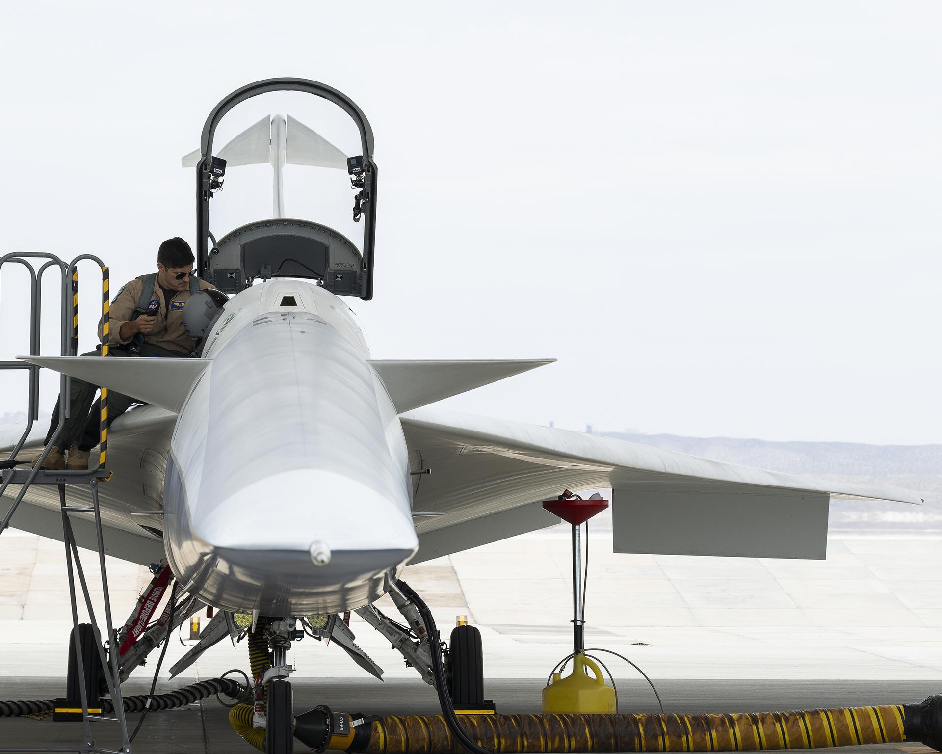Mike Lippert, one of NASA’s X‑59 test pilots, climbs into the aircraft’s cockpit for the first time during an engine run at NASA’s Armstrong Flight Research Center in Edwards, California, on Thursday, Aug. 27, 2026. Lippert is the third X‑59 pilot supporting NASA’s Quesst mission, which will demonstrate quiet supersonic flight over U.S. communities and gather public feedback on the aircraft’s quieter sonic “thump.”