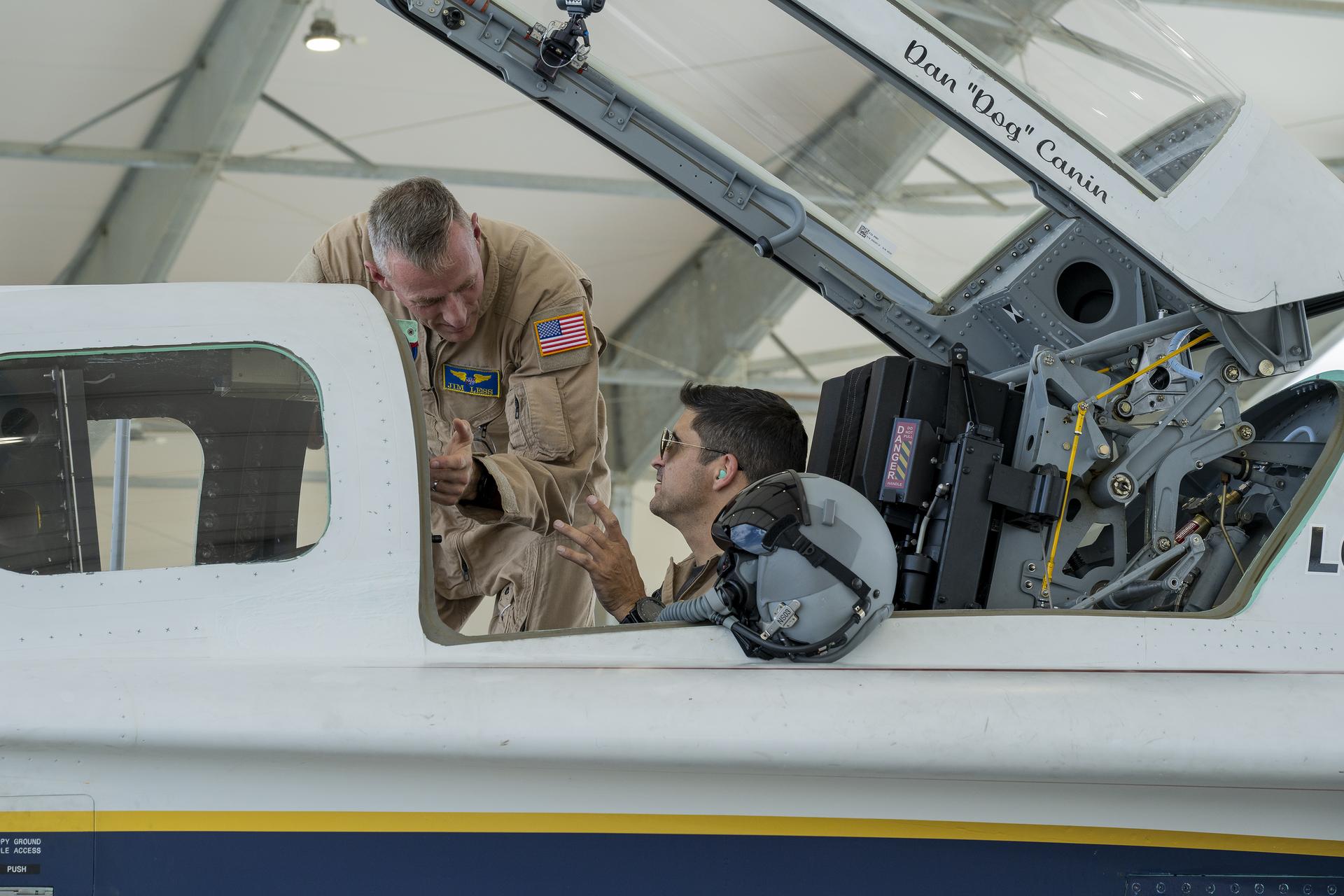 NASA X‑59 test pilots Mike Lippert, right, and Jim “Clue” Less review details prior to an engine run of the agency’s X‑59 quiet‑supersonic research aircraft at NASA’s Armstrong Flight Research Center in Edwards, California, on Thursday, Aug. 27, 2026. The test marked Lippert’s first opportunity to operate the aircraft and become familiar with its cockpit. NASA’s Quesst mission aims to demonstrate quiet supersonic flight over U.S. communities and gather public feedback on the aircraft’s quieter sonic “thump.”