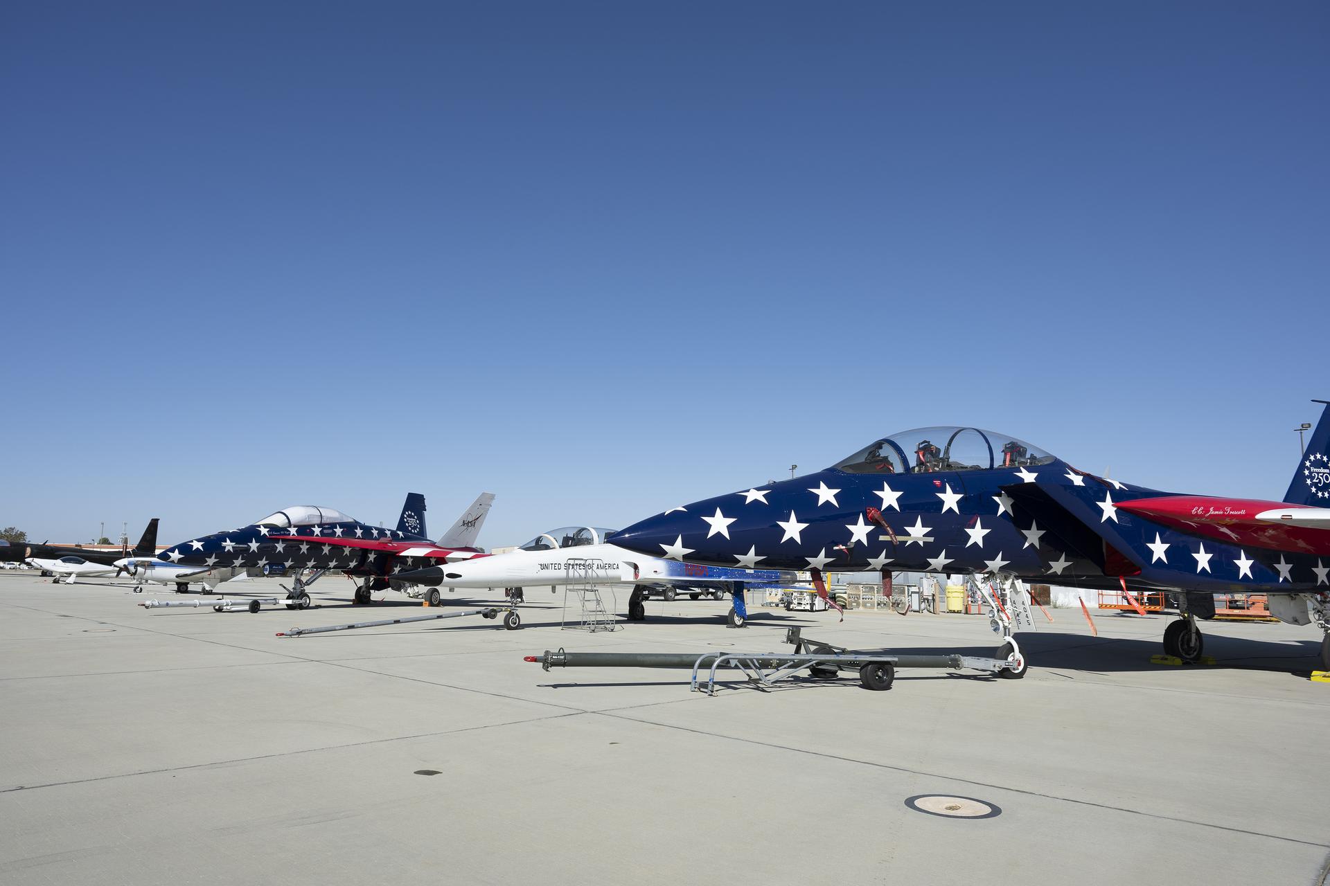 NASA’s F/A-18, a Northrop F-5 Tiger II, and NASA’s F-15 are on static display at Red, White, and Boom, the U.S. Air Force Test Center’s celebration of America’s 250th anniversary and NASA Armstrong’s commemoration of its 80th year at Edwards Air Force Base, California, on Friday, Sept. 18, 2026. The event brought together the workforce, families, and the Edwards community for a high‑energy day featuring a Flightline 5K, Ramp Fest and STEM Expo, static aircraft displays, hands‑on STEM activities, and a NASA flyover with a sonic boom.