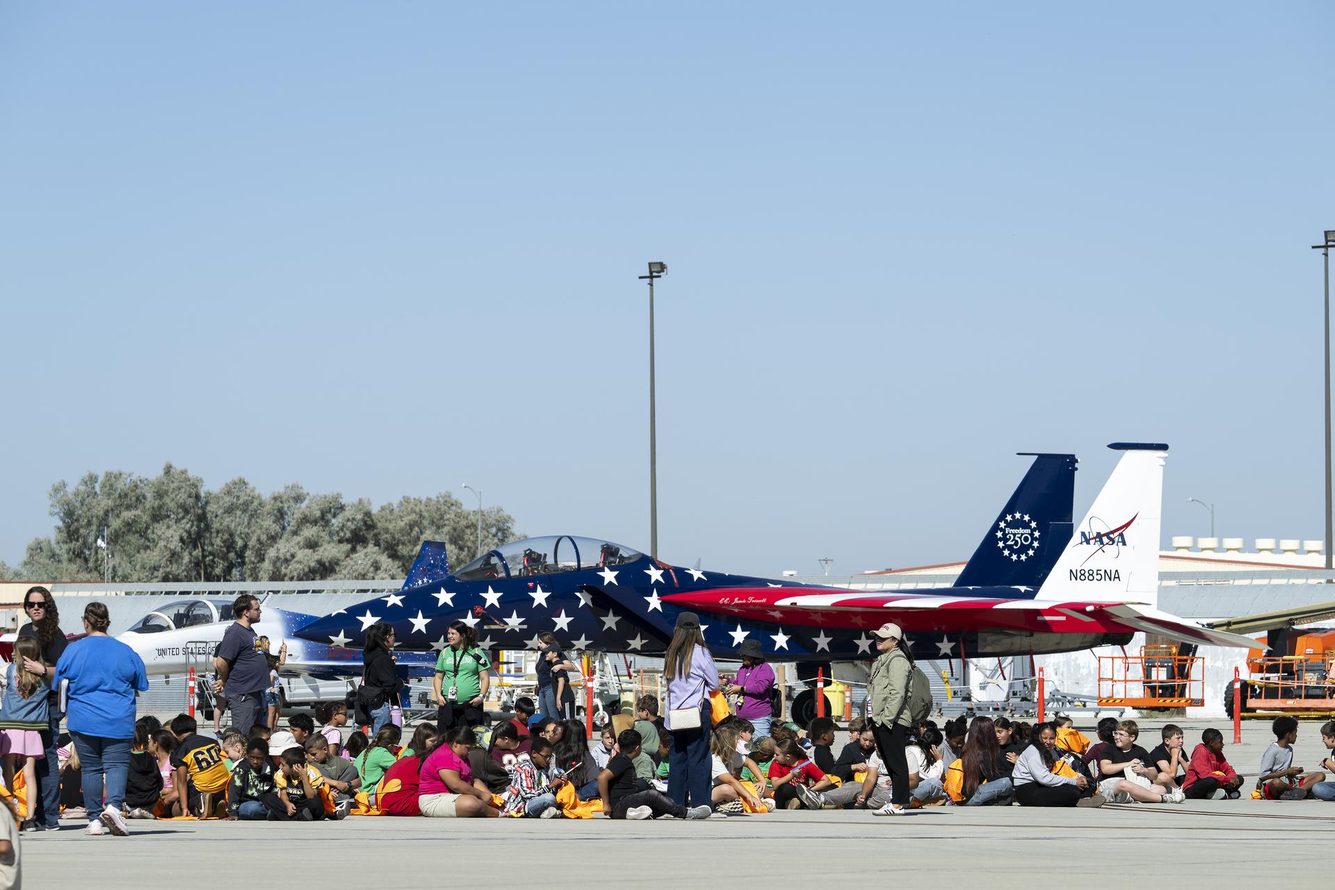 NASA’s F/A-18 and a Northrop F-5 Tiger II are on static display at Red, White, and Boom, the U.S. Air Force Test Center’s celebration of America’s 250th anniversary and NASA Armstrong Flight Research Center’s commemoration of its 80th year at Edwards Air Force Base, California, on Friday, Sept. 18, 2026. The event brought together the workforce, families, and the Edwards community for a high‑energy day featuring a Flightline 5K, Ramp Fest and STEM Expo, static aircraft displays, hands‑on STEM activities, and a NASA flyover with a sonic boom.