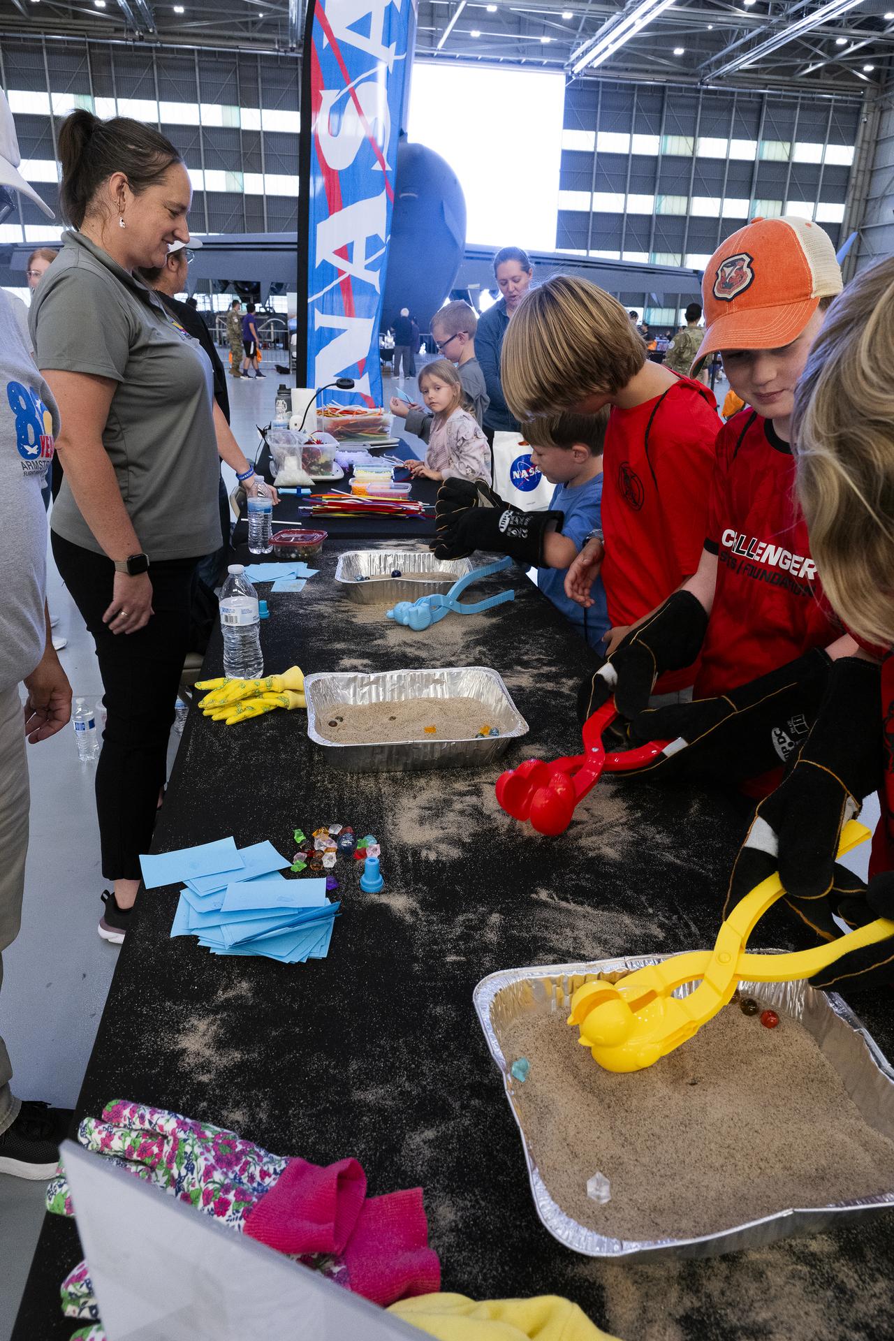 Students patriciate in educational activities provided by NASA’s Armstrong Flight Research Center Office of STEM Engagement during Red, White, and Boom, the U.S. Air Force Test Center’s celebration of America’s 250th anniversary and NASA Armstrong’s commemoration of its 80th year at Edwards Air Force Base, California, on Friday, Sept. 18, 2026. The event brought together the workforce, families, and the Edwards community for a high‑energy day featuring a Flightline 5K, Ramp Fest and STEM Expo, static aircraft displays, hands‑on STEM activities, and a NASA flyover with a sonic boom.