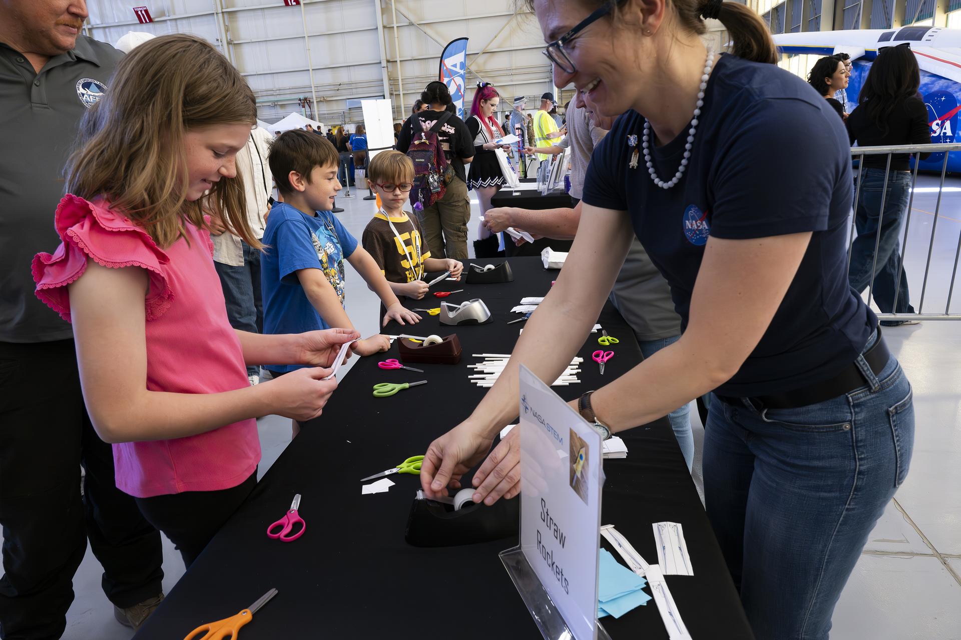 Students patriciate in educational activities provided by NASA’s Armstrong Flight Research Center Office of STEM Engagement during Red, White, and Boom, the U.S. Air Force Test Center’s celebration of America’s 250th anniversary and NASA Armstrong’s commemoration of its 80th year at Edwards Air Force Base, California, on Friday, Sept. 18, 2026. The event brought together the workforce, families, and the Edwards community for a high‑energy day featuring a Flightline 5K, Ramp Fest and STEM Expo, static aircraft displays, hands‑on STEM activities, and a NASA flyover with a sonic boom.