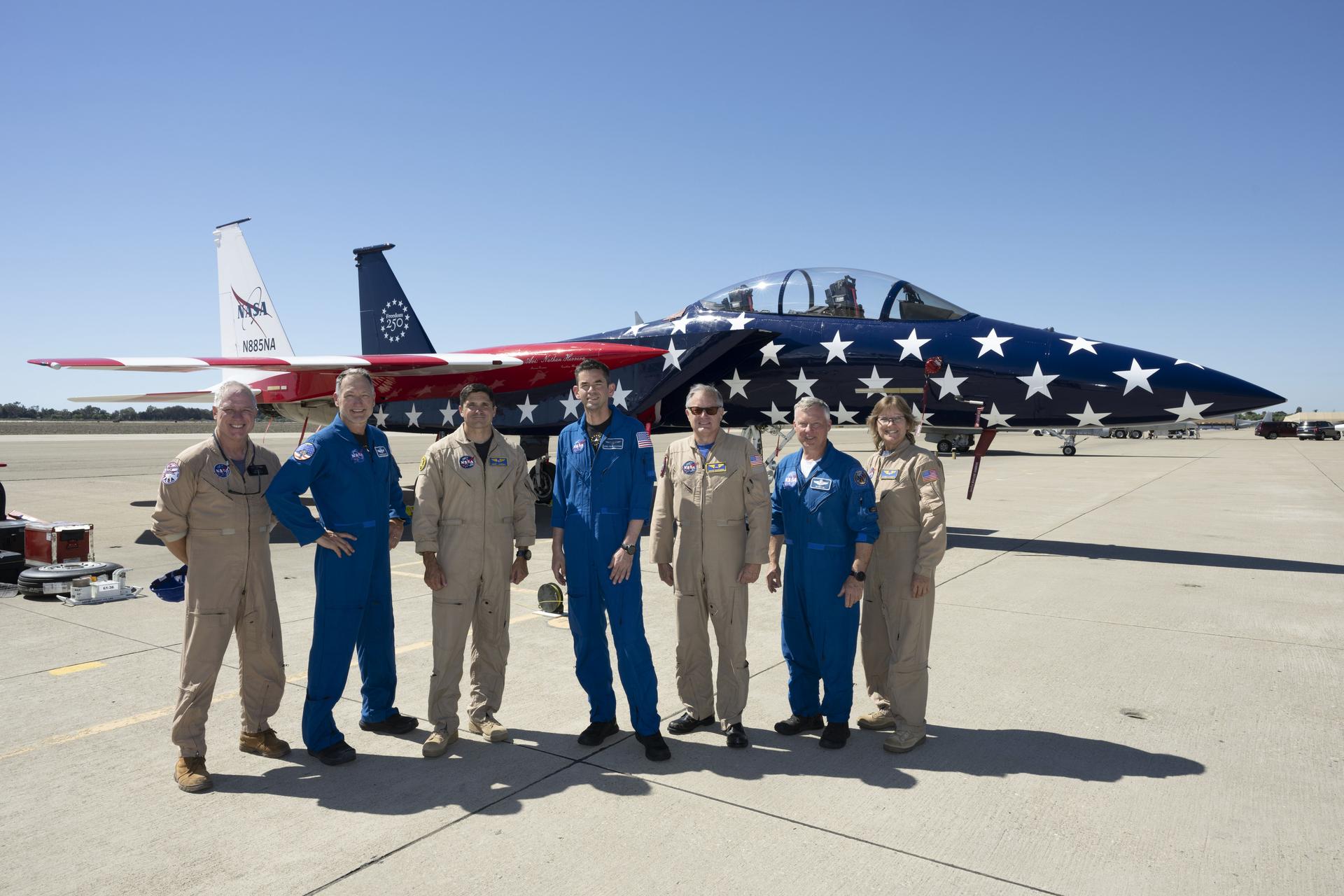 NASA’s 15th Administrator Jared Issacman, center, poses with, from left, NASA photographer Jim Ross; Sean Gustafson, senior advisor to the administrator; NASA pilot Mike Lippert; NASA pilot Wayne Ringelberg; Todd Ericson, senior advisor to the administrator; and videographer Lori Losey in front of agency’s newly painted F‑15, which honors America’s 250th birthday, during the Pacific Airshow in Huntington Beach, California, Saturday, Oct. 3, 2026.