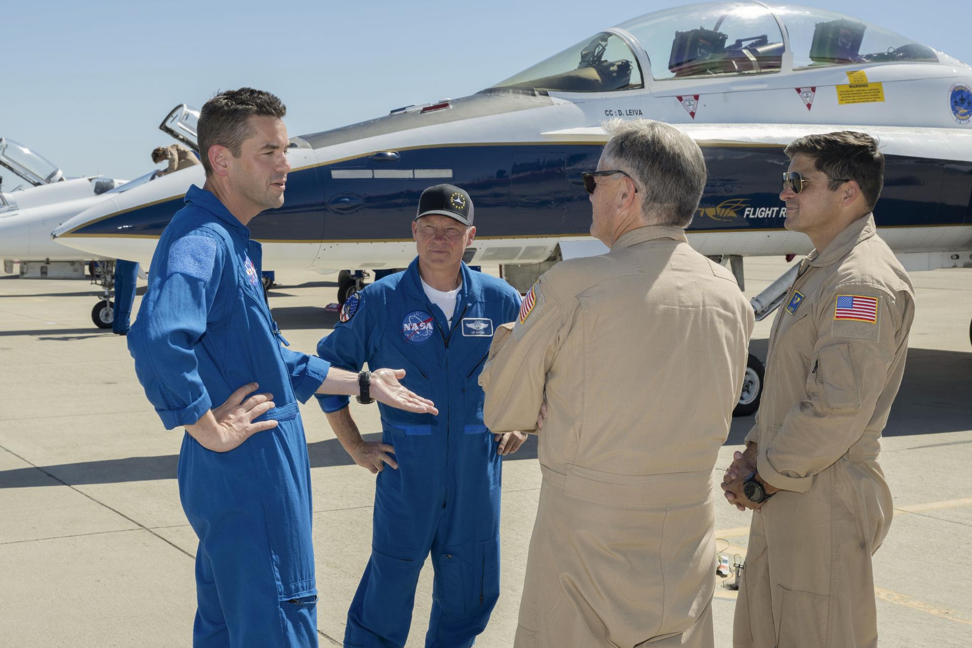 NASA’s 15th Administrator Jared Issacman, left, speaks with, from left, Todd Ericson, senior advisor to the administrator, NASA pilot Mike Lippert, and NASA pilot Wayne Ringelberg at Los Alamitos Joint Forces Training Base, California, Saturday, Oct. 3, 2026. Behind them is the agency’s F/A-18 aircraft, which Lippert and Ringelberg flew during the Pacific Airshow in Huntington Beach, California, Oct. 2-4.