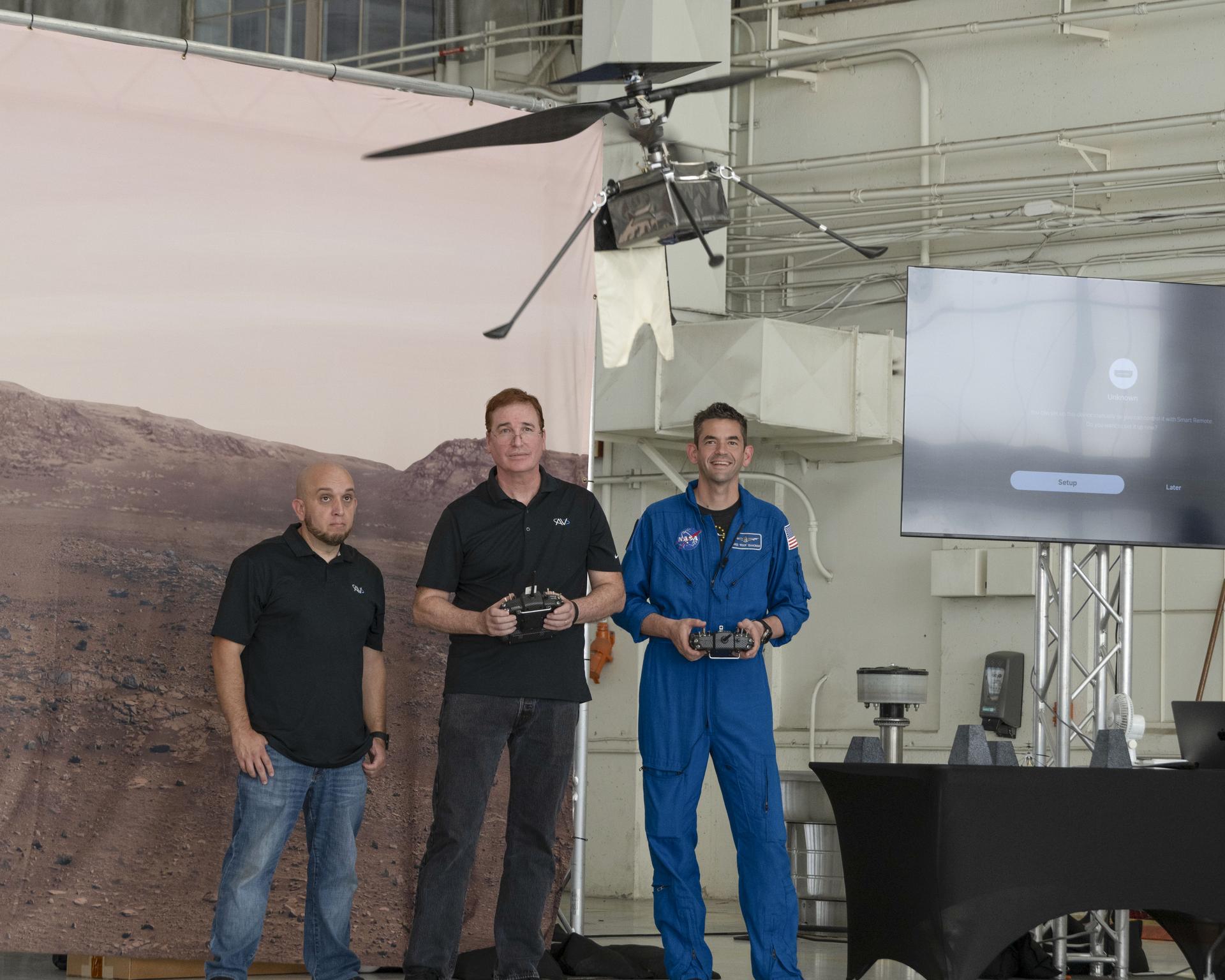 NASA’s 15th Administrator Jared Issacman, right, flies SkyFall, the next evolution of Mars helicopters, during Jet Propulsion Laboratory’s demonstration at Los Alamitos Joint Forces Training Base, California, Saturday, Oct. 3, 2026. Next to him is AeroVironment team members Matt Keenon, center, and Steve Quintero.
