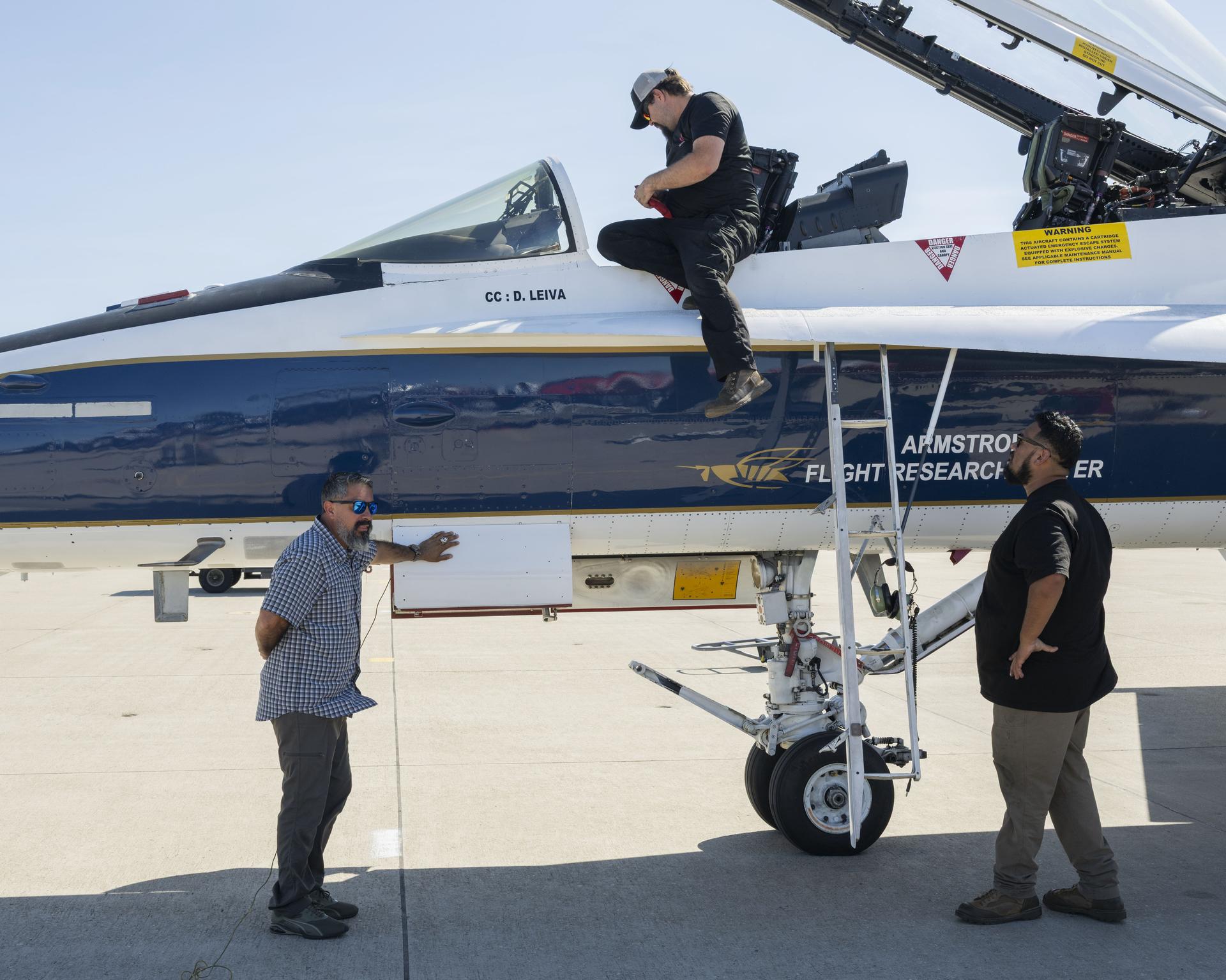 NASA quality assurance specialist Alejandro Rodriguez Mendez; Cameron Copple, F/A-18 crew chief; and F/A-18 mechanic Michael Lara inspect the aircraft at Los Alamitos Joint Forces Training Base, California, Sunday, Oct. 4, 2026. The jet was among the NASA aircraft that flew in the Pacific Airshow in Huntington Beach, California, Oct. 2-4.