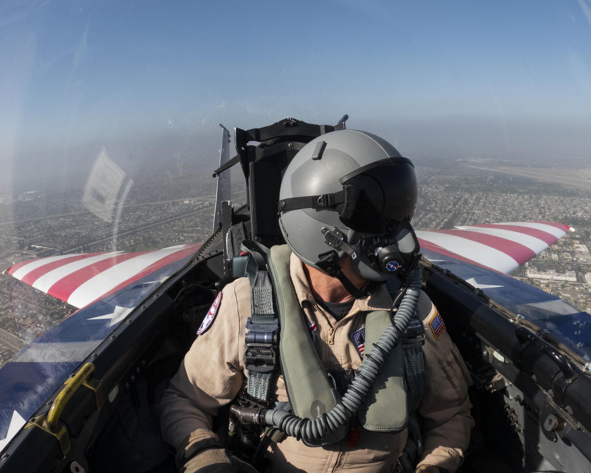 NASA photographer Jim Ross rides in the back seat of the agency’s newly painted F‑15, which honors America’s 250th birthday, during a transit flight to Huntington Beach, California, piloted by NASA test pilot Wayne Ringelberg, Thursday, Oct. 1, 2026. The aircraft will fly in the Pacific Airshow, Oct. 2-4.