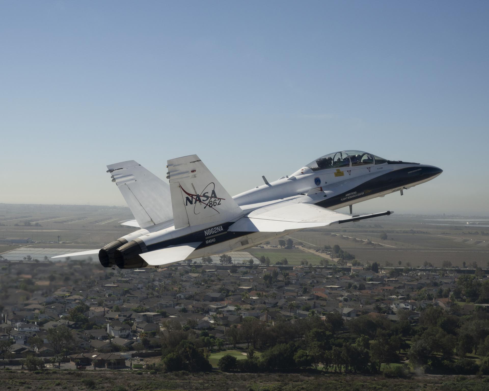 NASA test pilot Mike Lippert flies an F/A‑18 with videographer Lori Losey in the back seat during a Pacific Airshow flyover at Huntington Beach, California, Friday, Oct. 2, 2026. NASA is also hosting an exhibit featuring Artemis, the X‑59, SkyFall, a lunar globe, and an Apollo 15 Moon rock, with pilots and research experts available throughout the weekend.