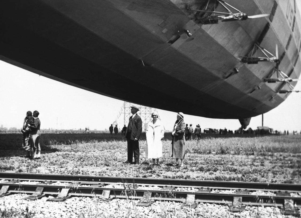 USS AKRON at Moffett Field, Mr. & Mrs. Charles T. Johnson of San Jose and their daughter Ruth.  It was  possible for the public to park on the shoulder of Bayshore Freeway and walk out on the field to inspect the 'AKRON'.  No fences or security guards!