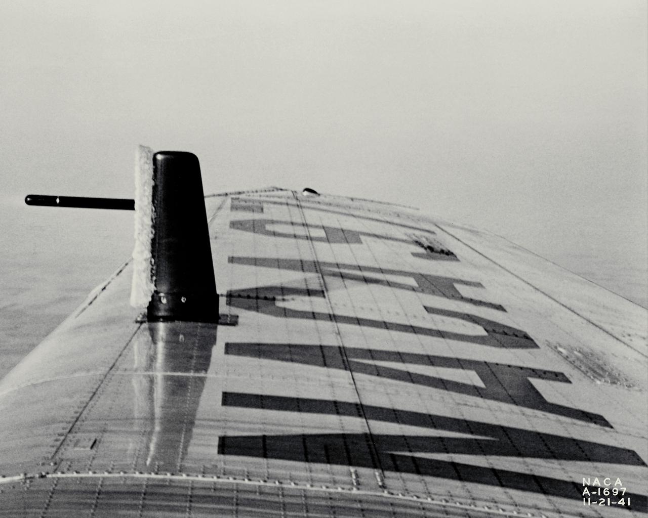 NACA photographer Ice Reearch being conducted at NACA Ames Aeronautical Laboratory on a Lockheed 12-A,  NACA 97; test #4, ice on tell-tale strut in flight