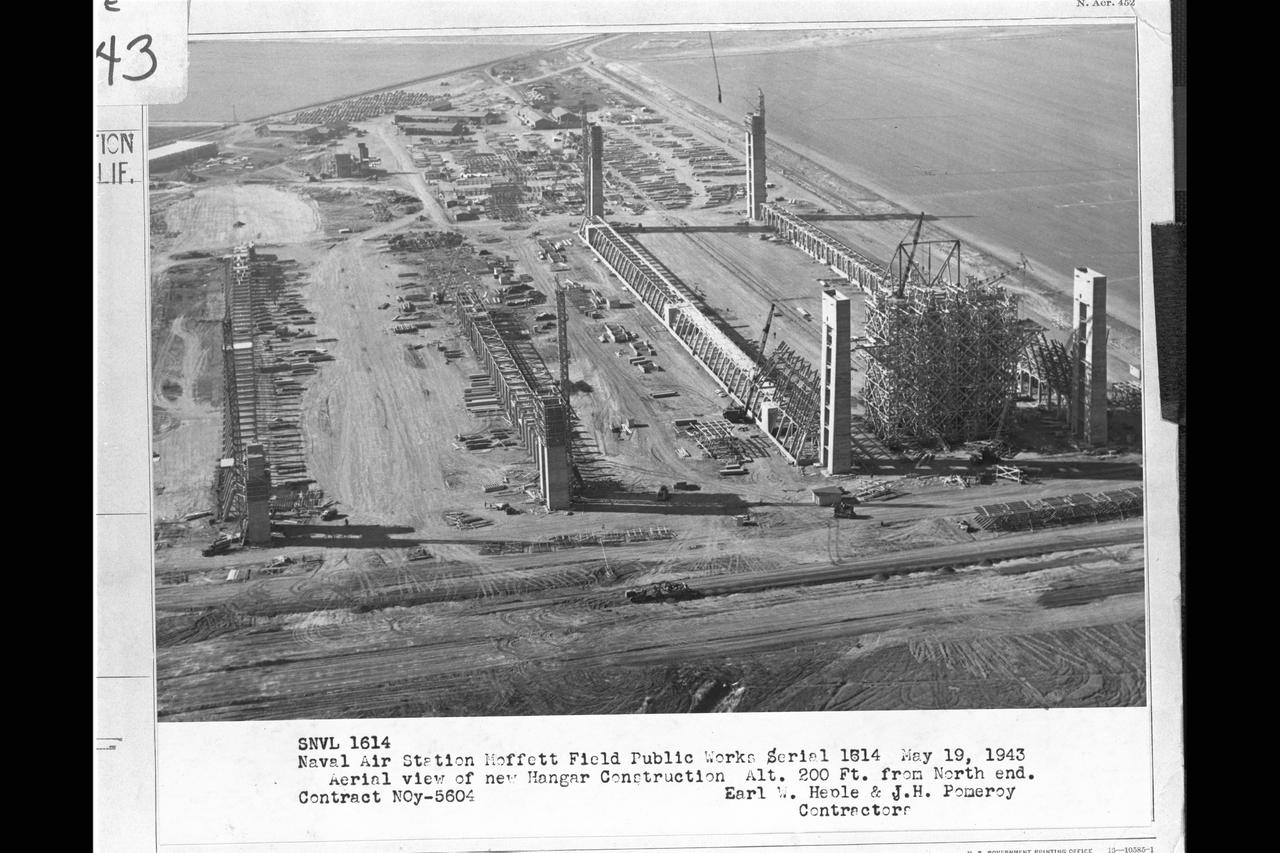 Navy Naval Air Station Moffett Field Public works Serial 1514 - Contract NOy-5604, Earl W. Heple & J.H. Pomeroy contractors NAS Moffett Field: Aerial view of new Hangar2 & Hangar 3 construction at alt 200 ft from north end.