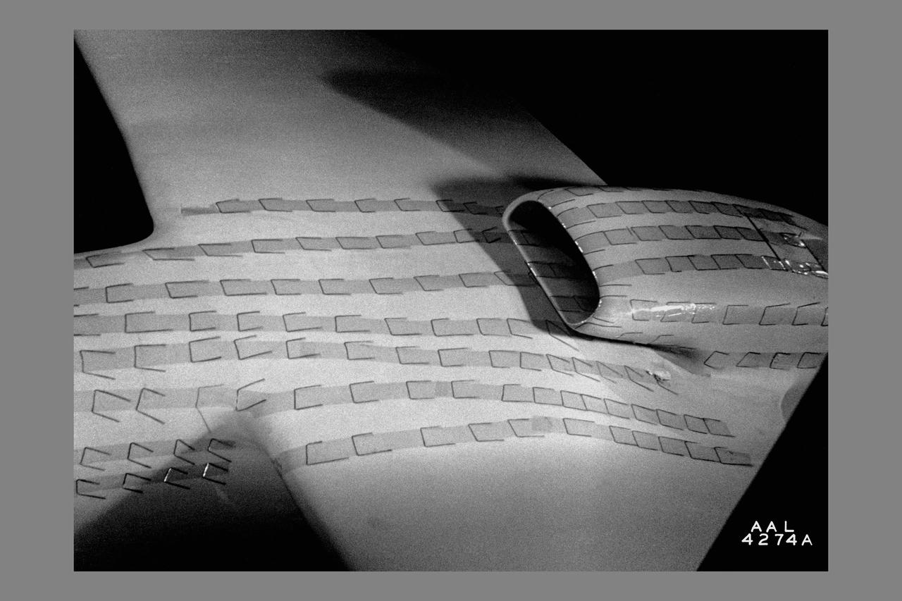 North American P-51B tuft studies done in the NACA Ames Research center 16ft Transonic Wind Tunnel Radiator air scoop with oil and prestone cooler exit flaps in flush position.