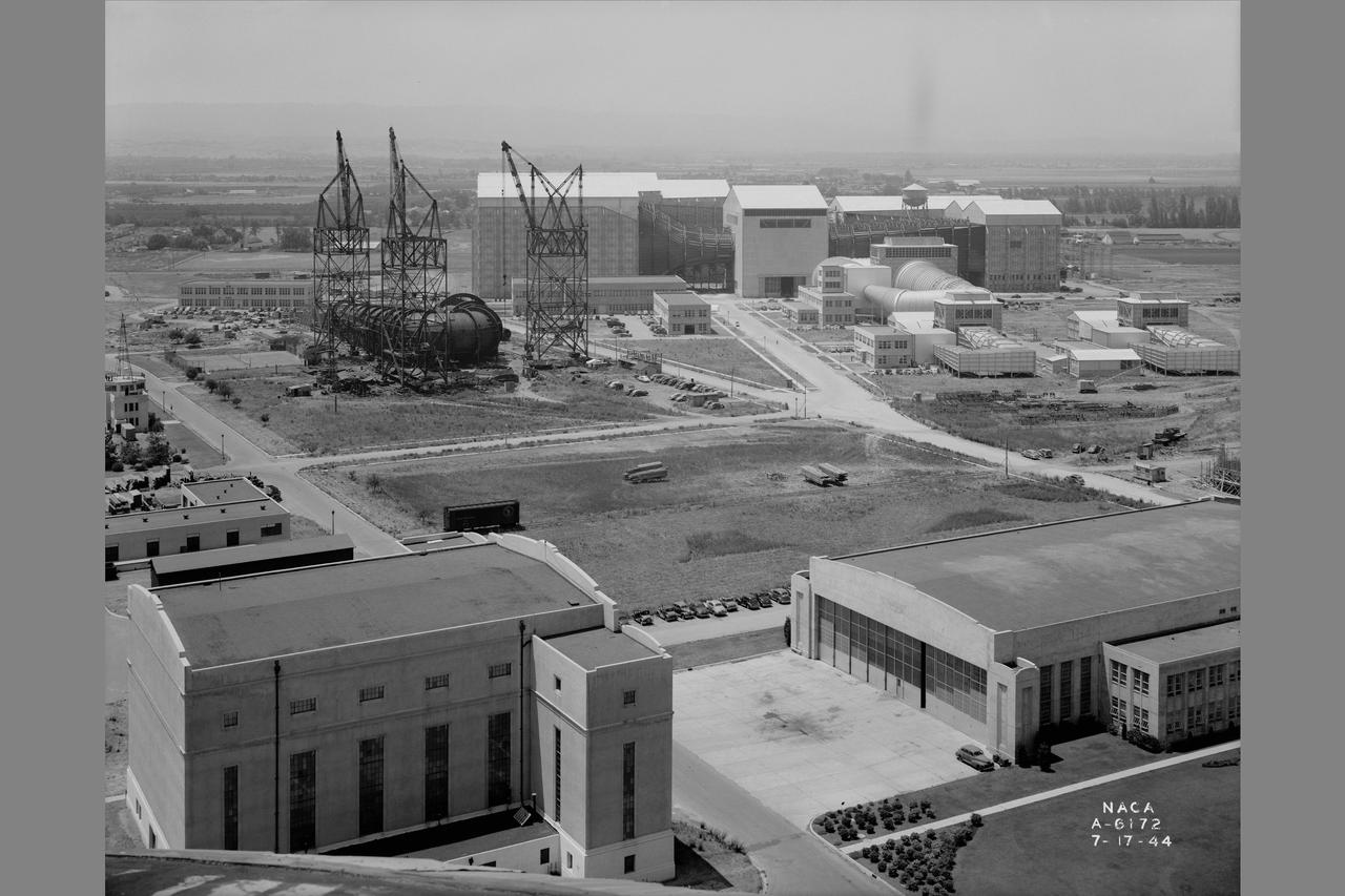 General view of Ames Aeronautical Laboratory taken from Naval airship hangar. Shows construction of the 12ft Pressure Wind Tunnel with large cranes.