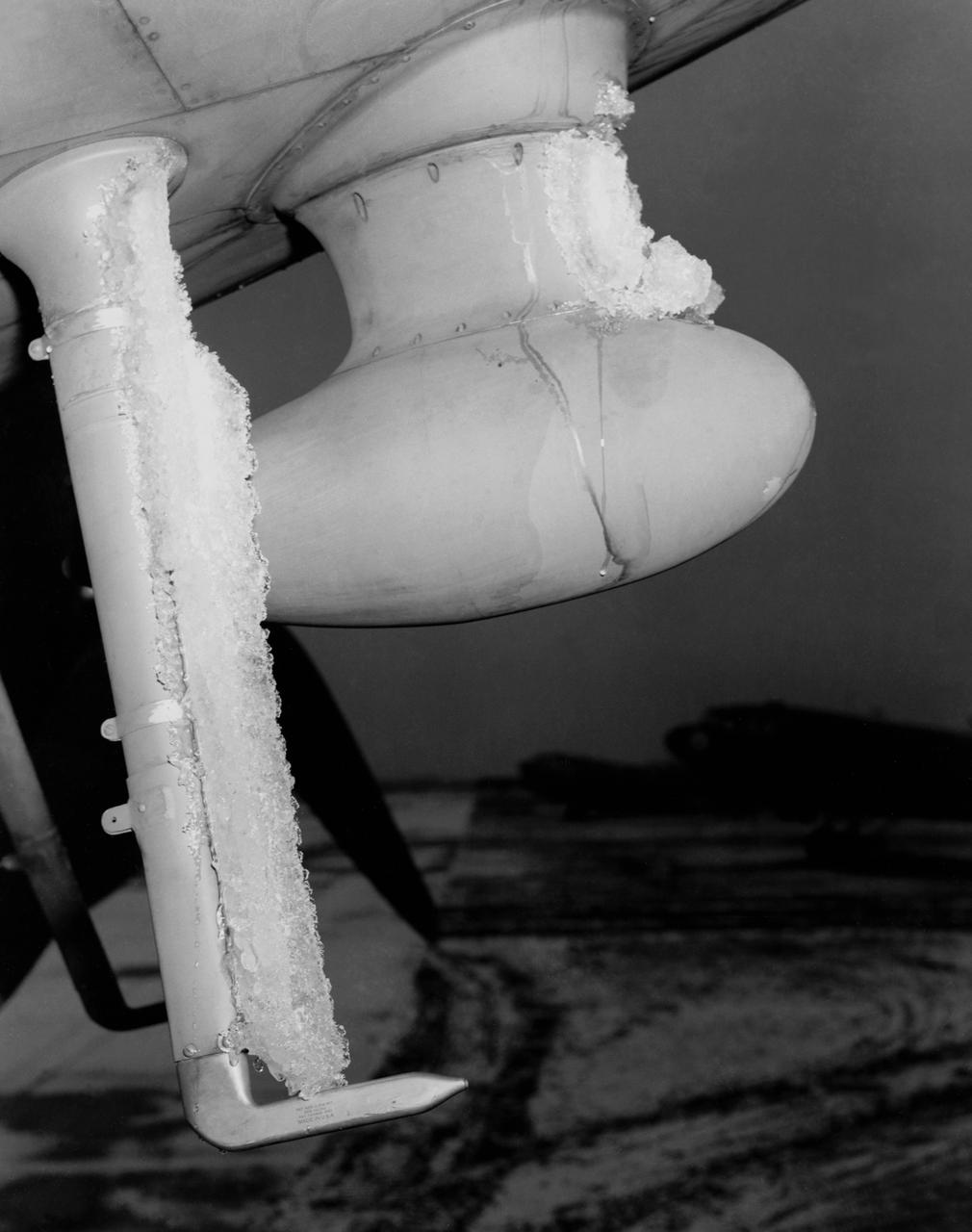 De-icing Research conducted at the NASA Ames Research Center. Icing flight test on C-46 airplane (flight 29 11:25am to 12:50 am)  glaze ice on loop antenna co-pilots airspeed mast.