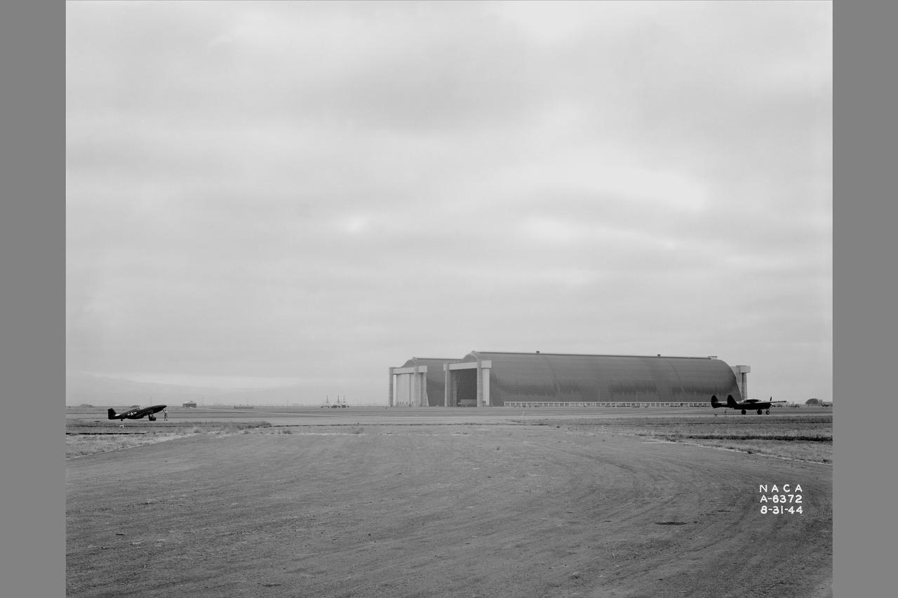 Towing installations on P-51 and P-61 airplanes for propeller off tests on the P-51 Front view of P-51 & P-61 in towing position preparing for take off at NACA Ames Research Center, Moffett Field, California