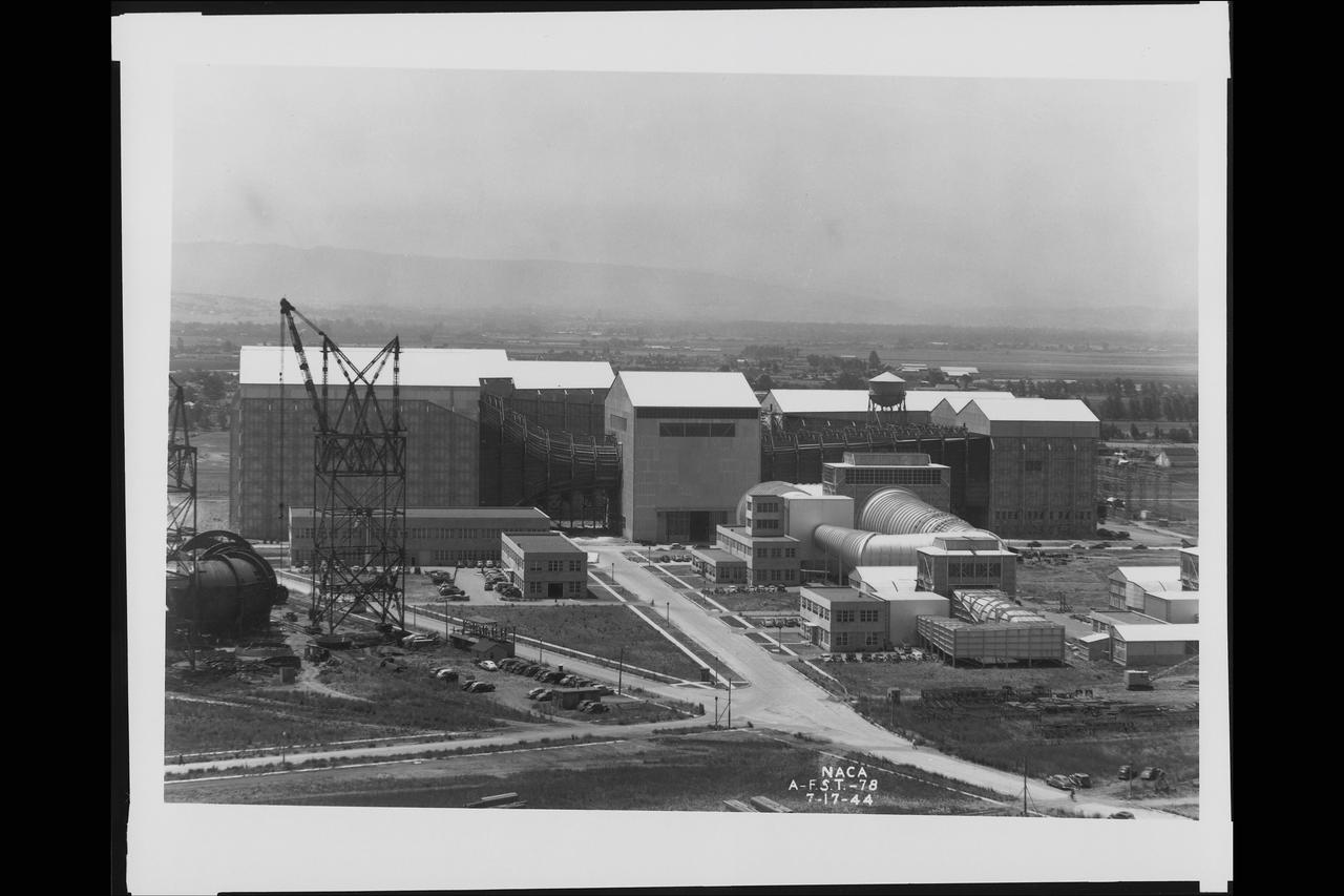 General view of Ames Subsonic 40x80ft wind tunnel from atop of the Moffett Naval Airship Hangar One (with construction of the Ames 12ft Pressure Wind Tunnel in forground)  July 17, 1944