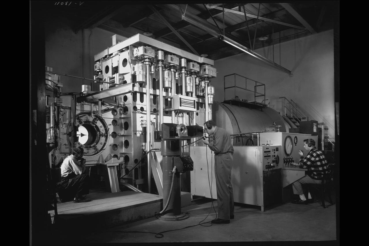NACA Photographer NASA Ames 1X3Ft W.T Blowdown, flexible throat:  A swept wing model readied for a test in June 1948, in the 1 by 3 foot blowdown tunnel with a variable geometry throat mechanism