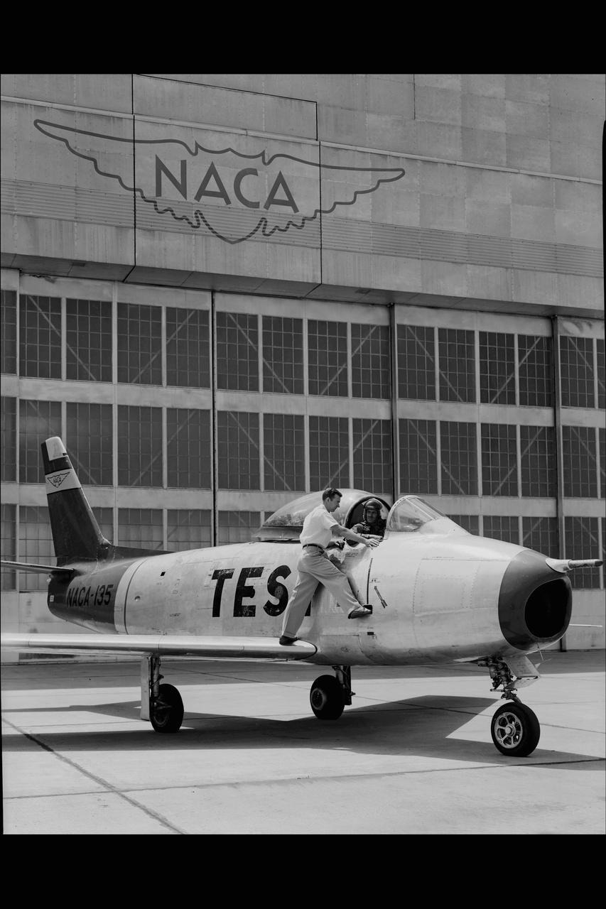 NORTH AMERICAN F86-A #135 AIRPLANE on Ames ramp in front of hangar 211 with NACA PILOTS COOPER  & CREER