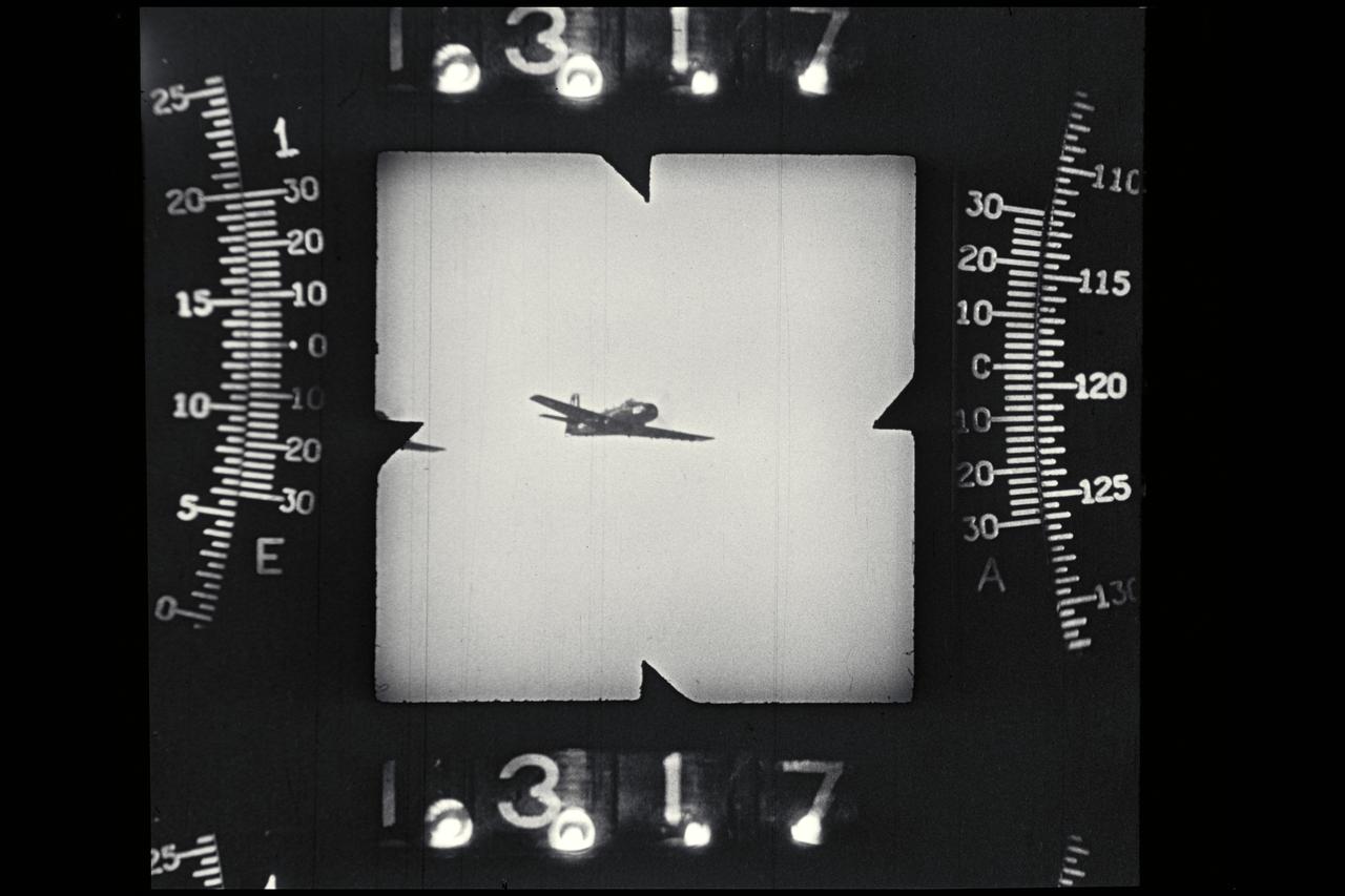 NACA photographer: Phototheodolite camera record image of P-51 in flight propellers on