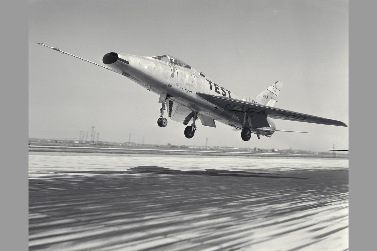 NACA Photographer North American F-100A (NACA-200) Super Sabre Airplane take-off. The blowing-tupe boundary-layer control on the leading- and trailing-edge provided large reductions in takeoff and landing approach speeds. Approach speeds were reduced by about 10 knots (Mar 1960). Note:  Used in publication in Flight Research at Ames;  57 Years of Development and Validation of Aeronautical Technology NASA SP-1998-3300 fig. 102 and and Memoirs of a Flight Test Engneer NASA SP-2002-4525