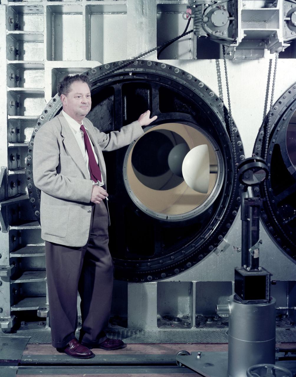 H. Julian 'Harvey'  Allen in front of the NASA Ames 8_x_7 foot Supersonic Wind Tunnel test section. A blunt body model mounted in the test section is ready for testing  . The 8_X_7_foot is part of the  Unitary Plan WInd Tunnel Complex  Note: printed in 60 year at NASA Ames Research Center by Glenn Bugos  NASA SP-2000-4314