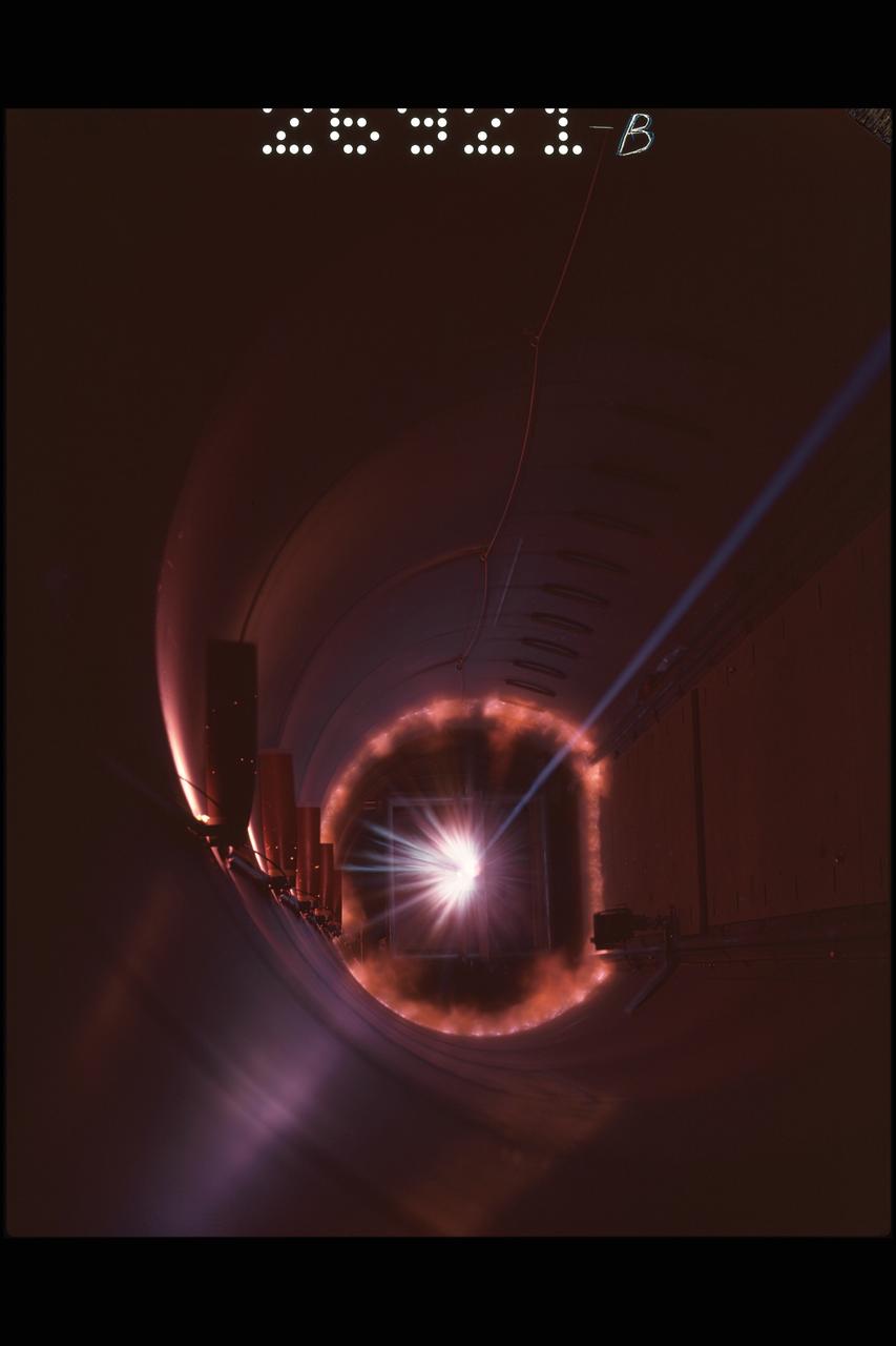 Hi-Speed impact test simulating space debris hitting an orbiting capsule. A blunt nose 20 millimeter model built of polyethylene hitting a aluminum target at 19,500 feet per second, in a pressure simulated as 100,000 feet altitude.