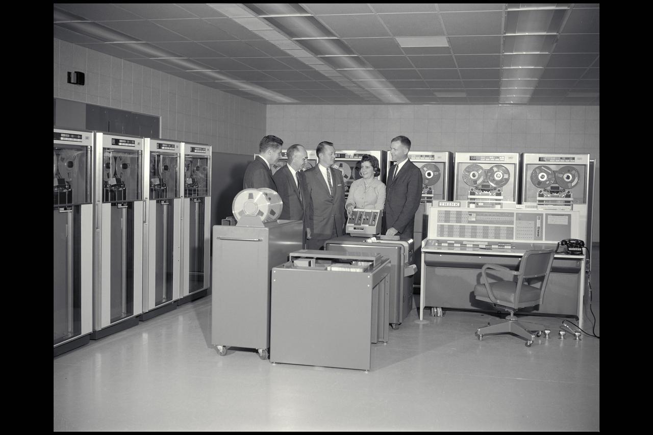 IBM 7090 computer and personnel: L-R: R Smith, IBM; Smith DeFrance, Ames; H Funk, IBM; Marcie Chartz Smith, Ames; D Swartz, IBM; discuss installation of computer at Ames.