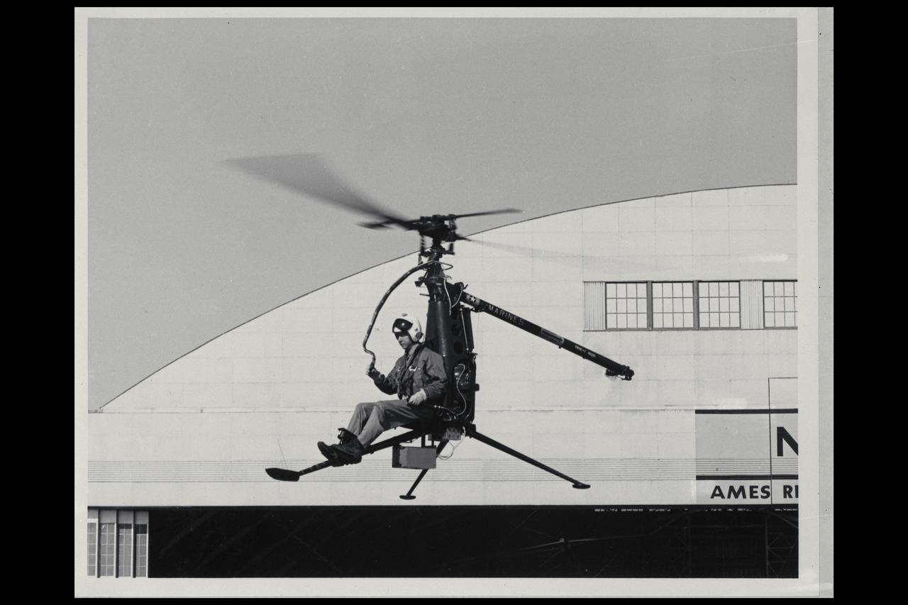 Ames aerodynamicists tested a wide variety of VTOL aircraft and helicopters during the 1960's Here the Hiller rotorcycle YROE-1, made by Hiller Helicopter in nearby Palo Alto, California, hovers in front of the Ames Hangar. The Rotorcycle was a small, 500pound, single-place helicopter. Tests indicated that the vehicle was unsafe because of low yaw-control capability to the right; the design also had oor crashworthiness.