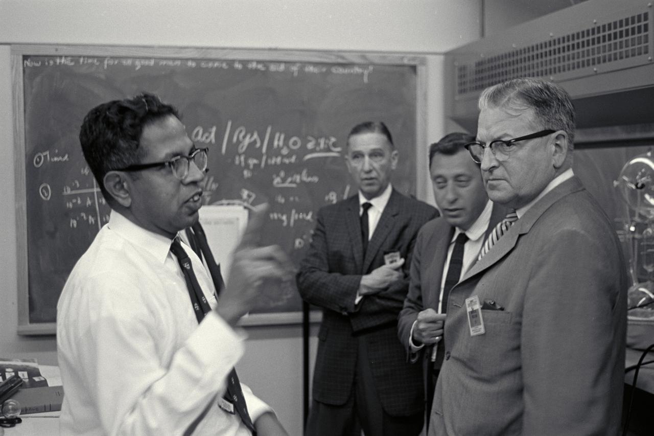 Dr Cyril Ponnamperuma and Dr Harold Klein discuss work with Congressman William K Van Pelt during visit and tour of Ames