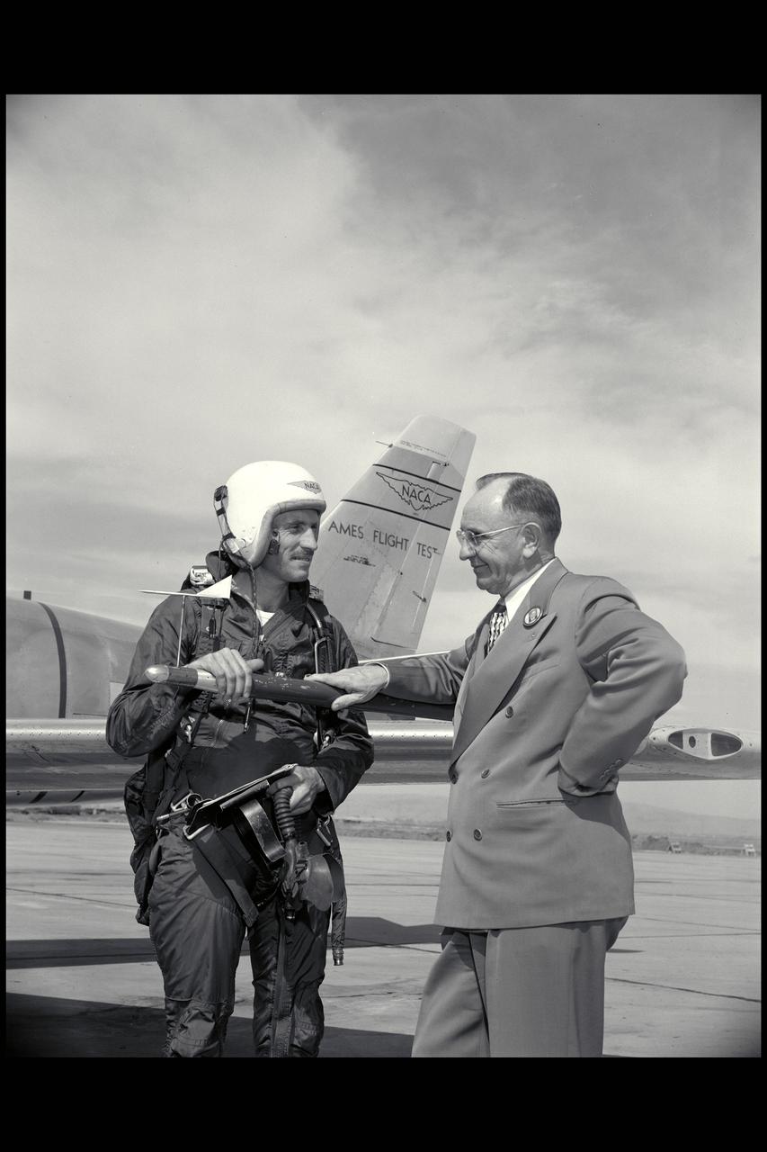 Ames Pilot George Cooper (l) and Ames Director Smith DeFrance discuss F-86 flight test